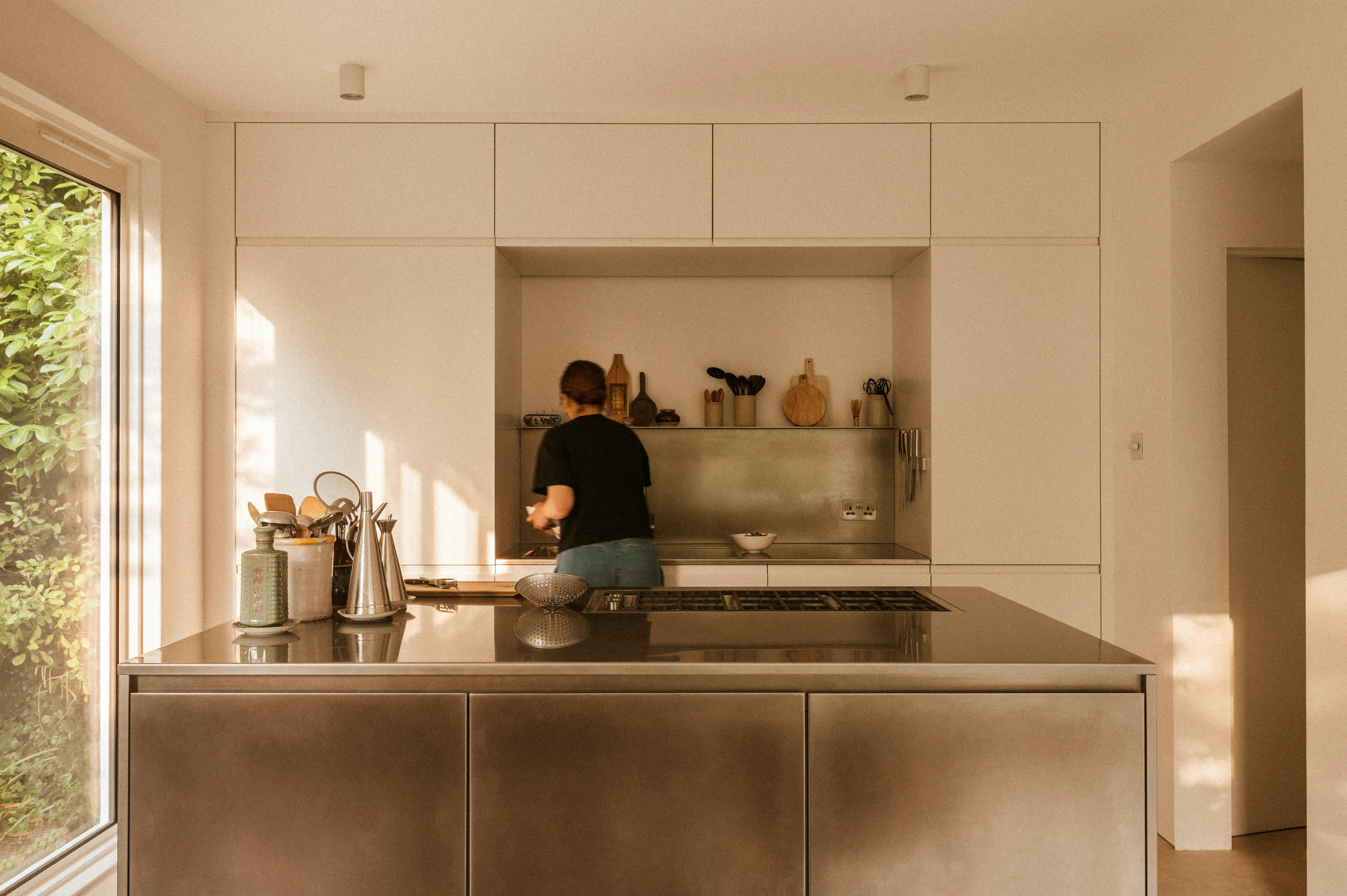 Minimal white painted and stainless steel Ma-kon kitchen.