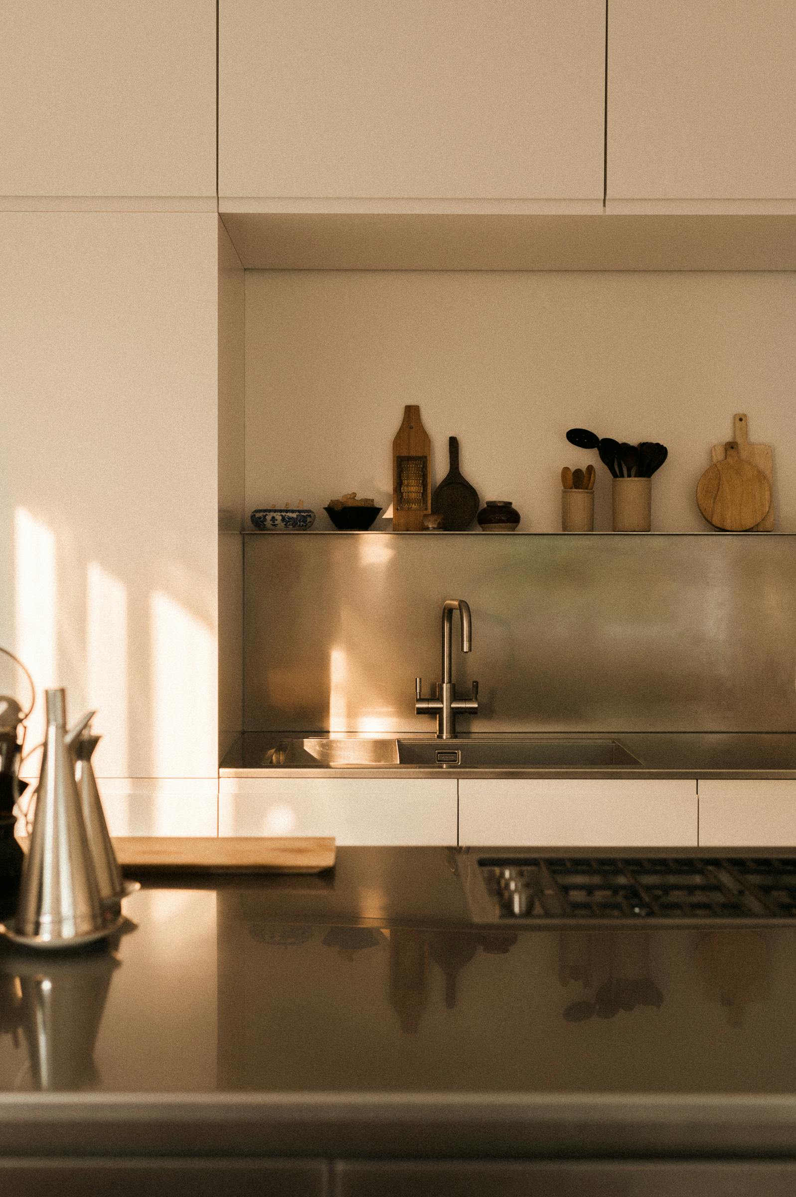 Minimal white painted and stainless steel Ma-kon kitchen.