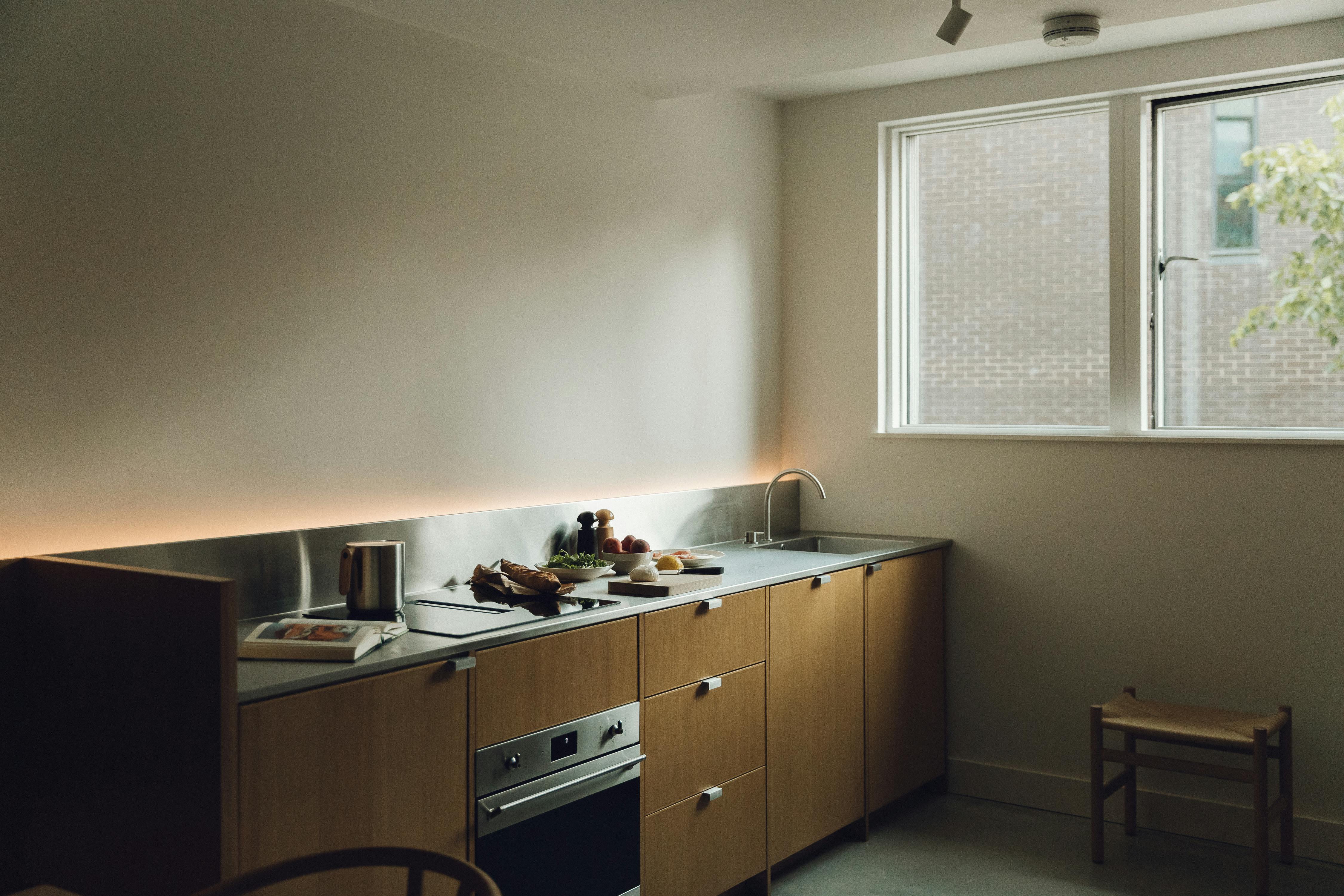 Contemporary oak and stainless steel Ma-kon kitchen.