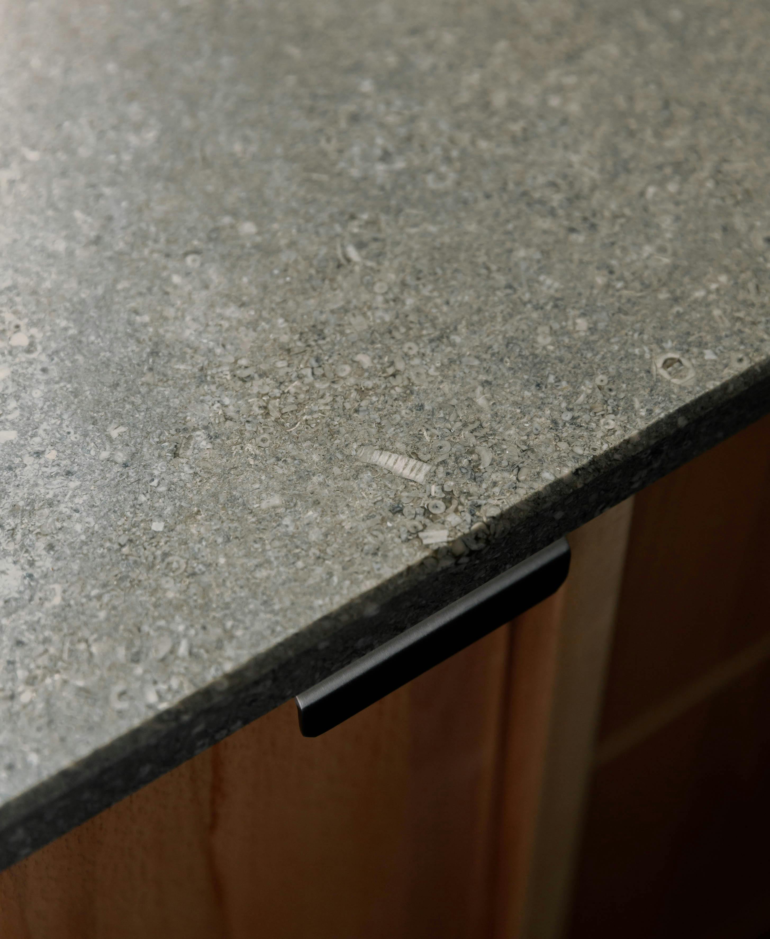 Contemporary wooden Ma-kon kitchen with limestone worktop.