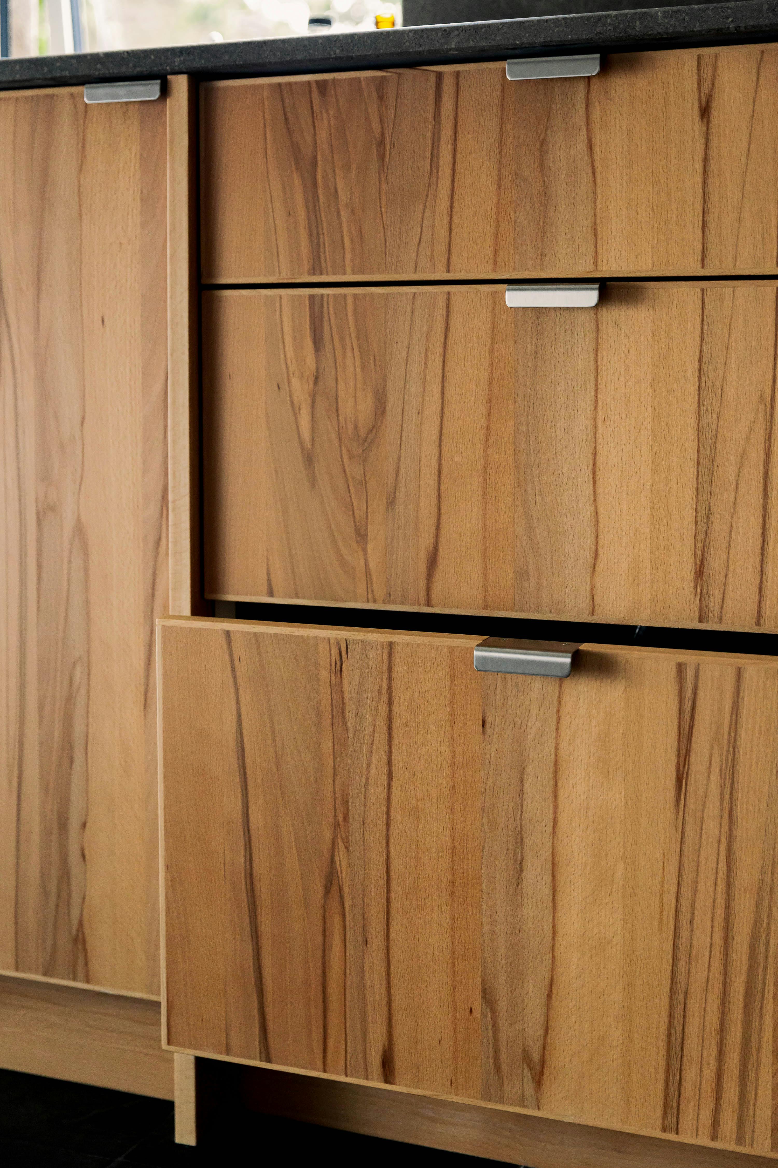 Contemporary wooden Ma-kon kitchen with limestone worktop.
