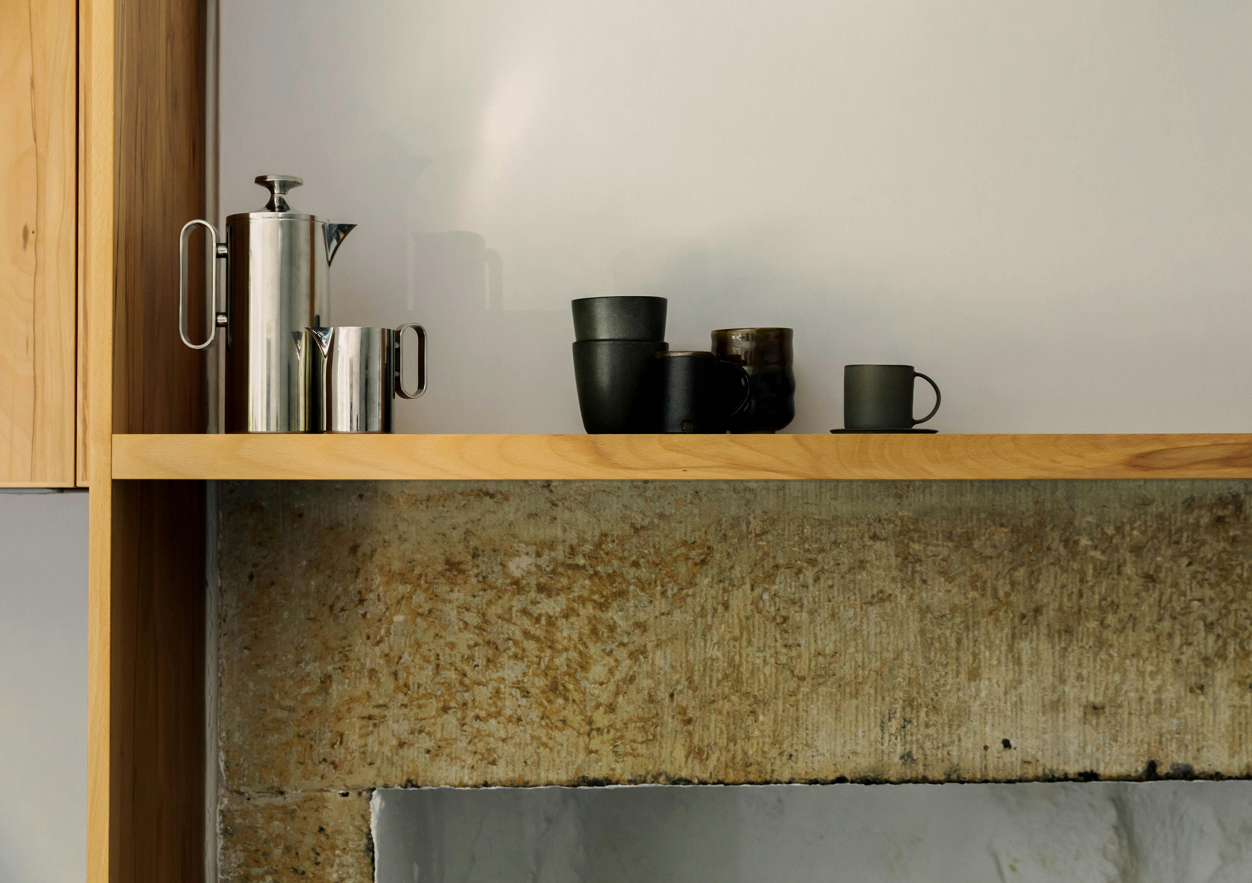 Contemporary wooden Ma-kon kitchen with limestone worktop.