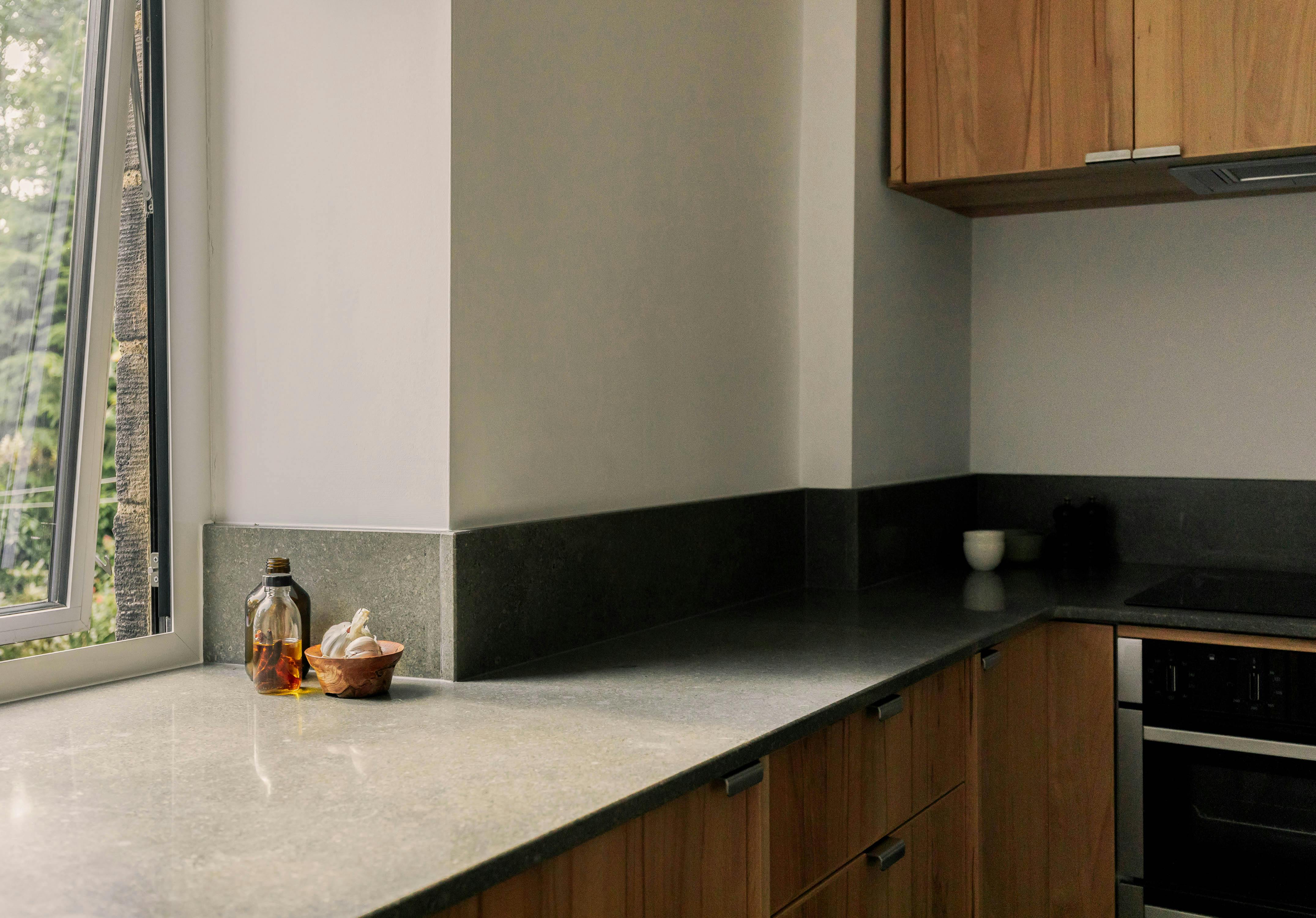 Contemporary wooden Ma-kon kitchen with limestone worktop.