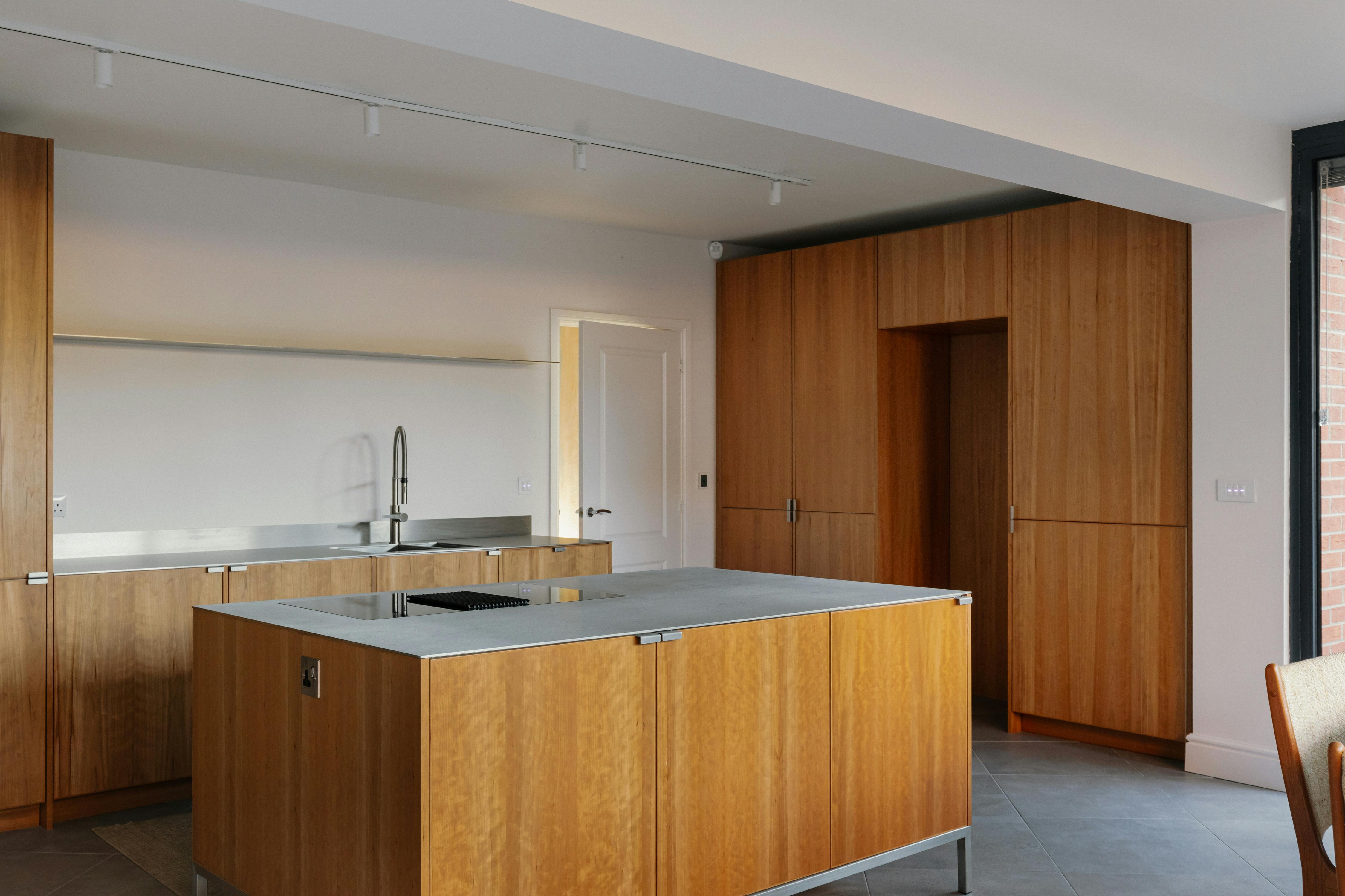 Contemporary cherry timber and stainless steel Ma-kon kitchen.