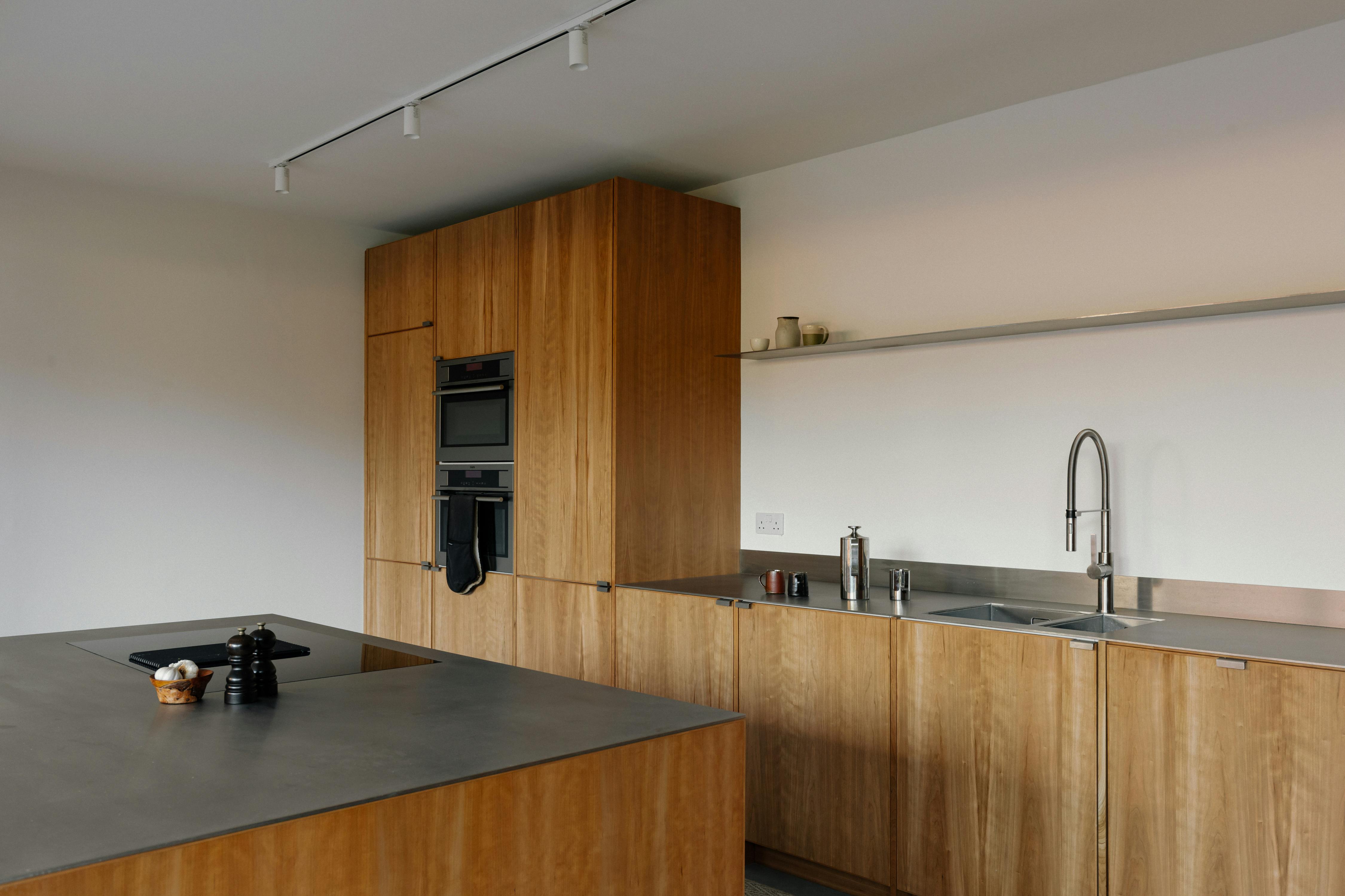 Contemporary cherry timber and stainless steel Ma-kon kitchen.