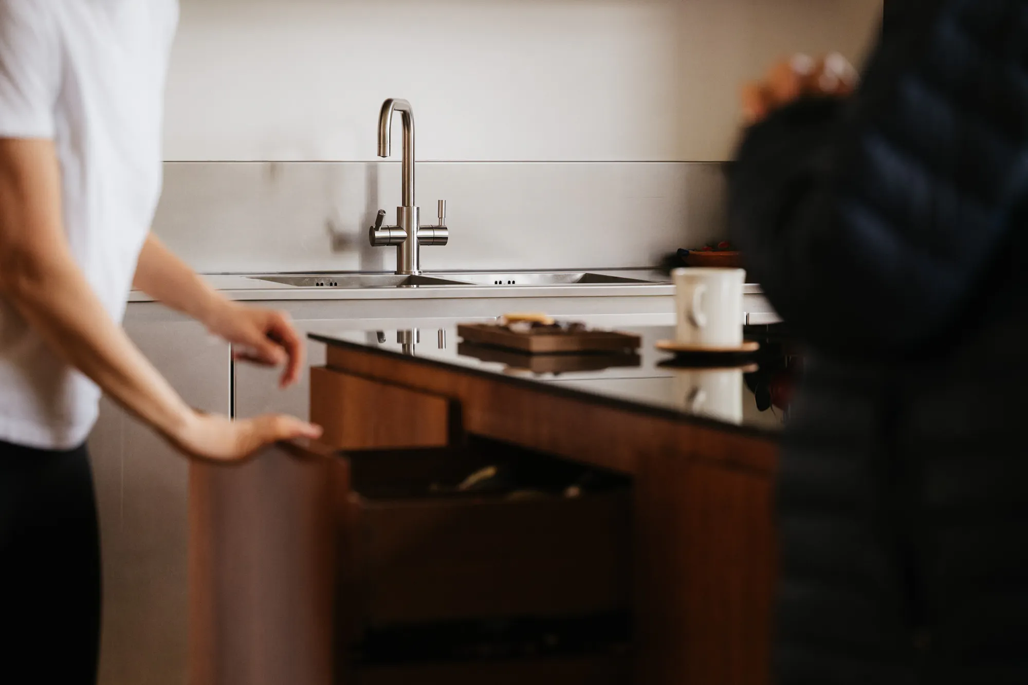 Cherry timber, black marble and stainless steel Ma-kon kitchen.
