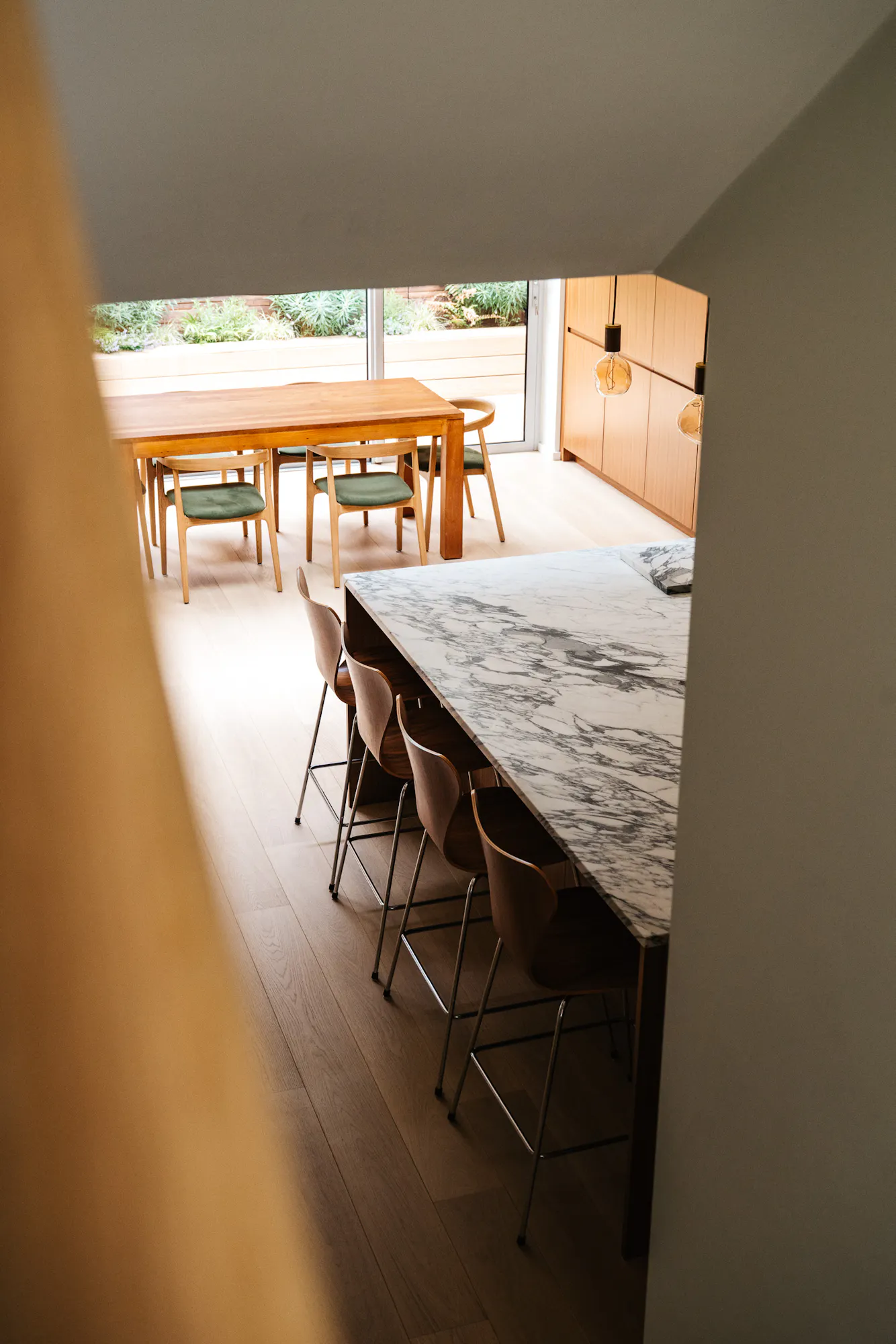 Contemporary walnut timber and arabescato marble Ma-kon kitchen.