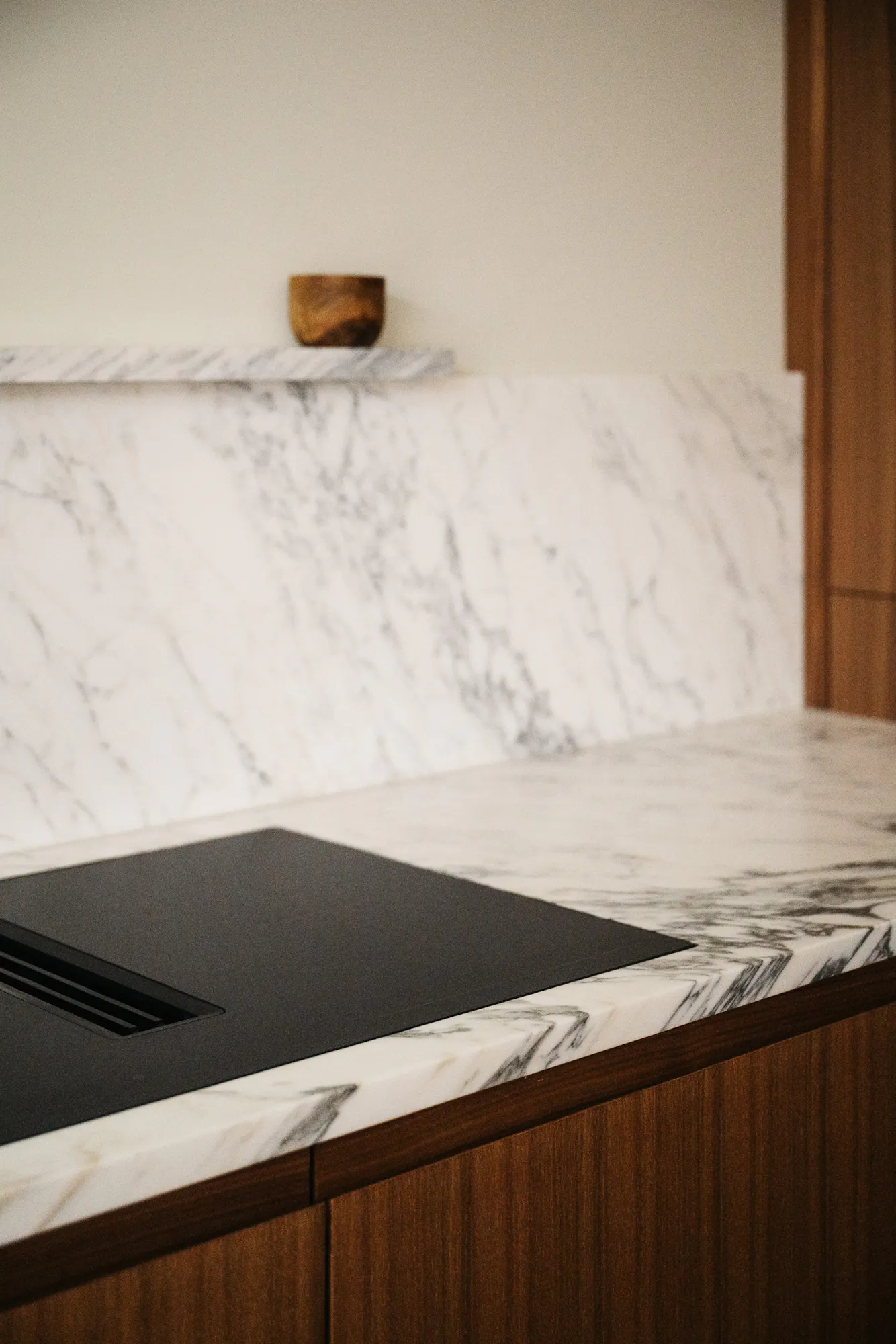 Contemporary walnut timber and arabescato marble Ma-kon kitchen.