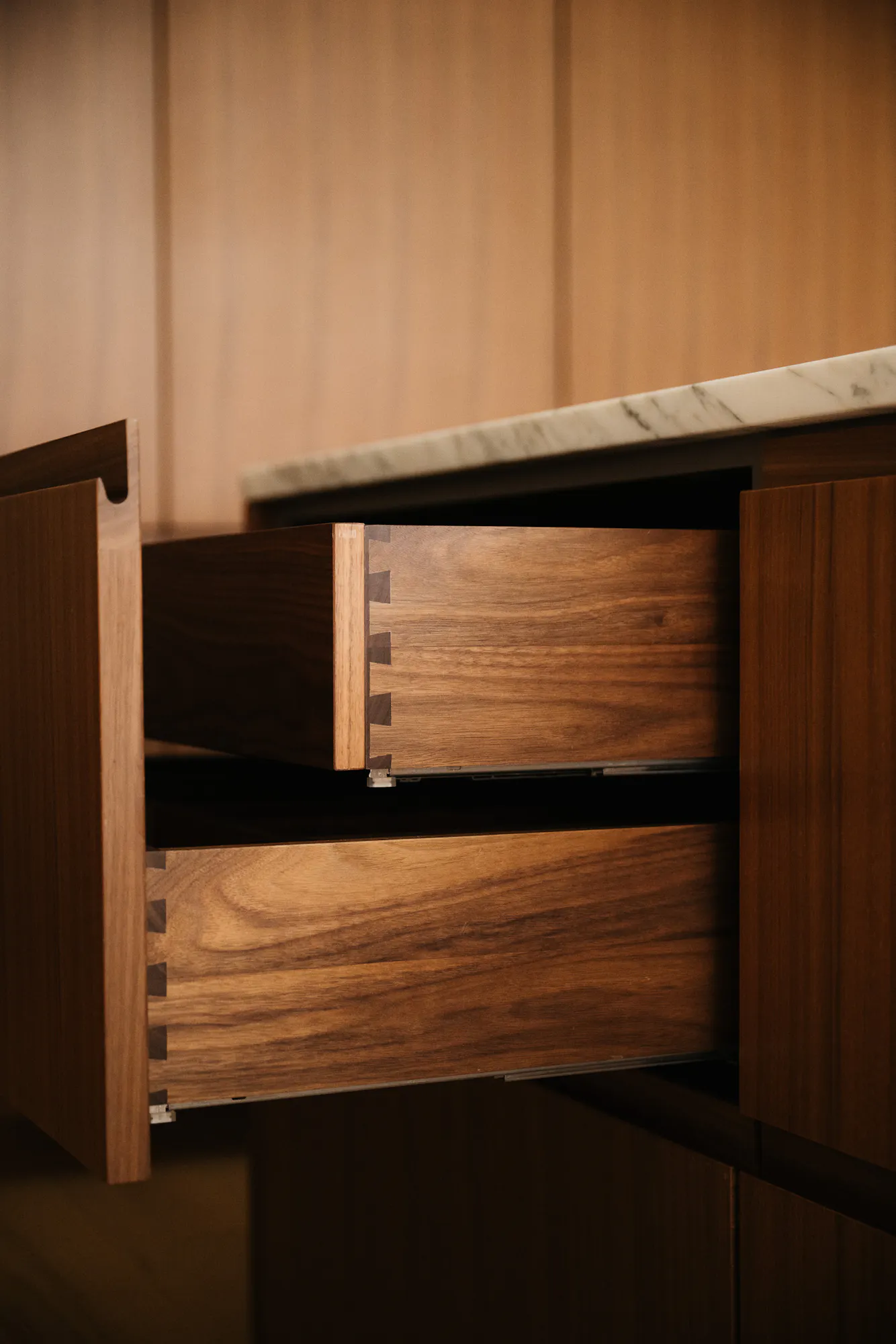 Contemporary walnut timber and arabescato marble Ma-kon kitchen.