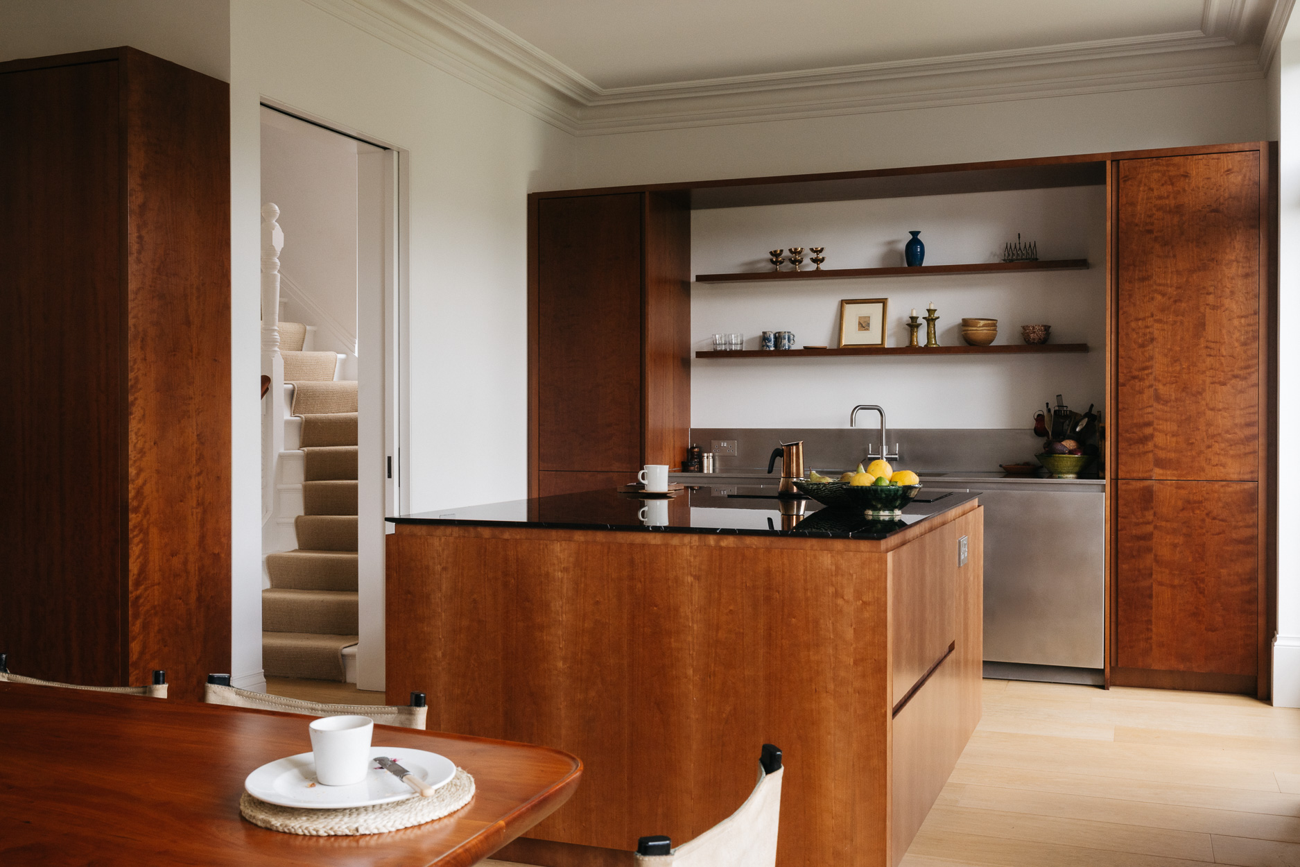 Cherry timber, black marble and stainless steel Ma-kon kitchen.