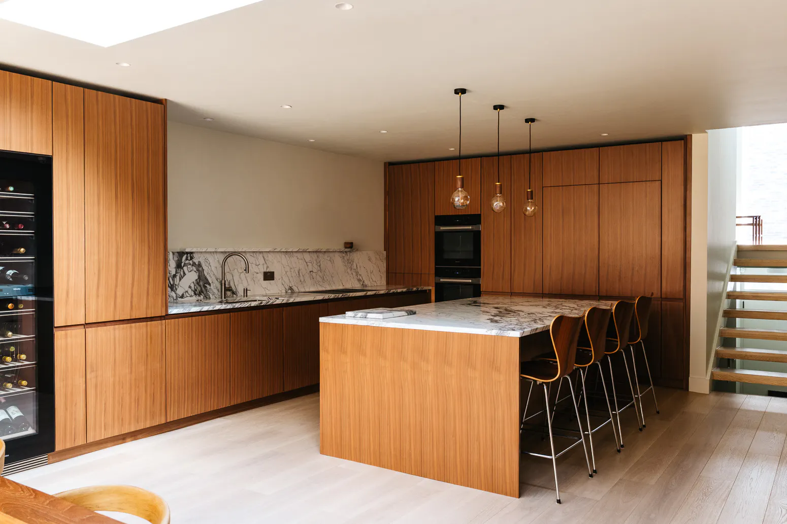 Contemporary walnut timber and arabescato marble Ma-kon kitchen.