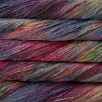 Picture of Brisa Aniversario: Rich jewel-toned yarn featuring deep plum and magenta with subtle accents of dusty teal, forest green, and warm golden ochre