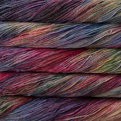 Picture of Brisa Aniversario: Rich jewel-toned yarn featuring deep plum and magenta with subtle accents of dusty teal, forest green, and warm golden ochre