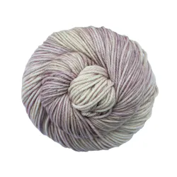 Picture of Malabrigo Rios Cancer: A soft and delicate colorway featuring a gentle blend of pale cream and ivory tones, beautifully variegated with subtle washes of dusty mauve, lavender, and muted rosy pink.