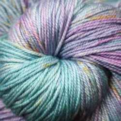 Picture of Malabrigo Yarn: A soft, dreamy pastel variegated colorway blending pale aqua turquoise and mint green with gentle lavenders and light purple tones, delicately speckled with golden mustard yellow flecks throughout.
