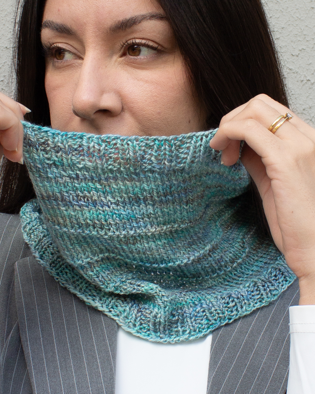 Woman wearing a hand-knit cowl in Torzal yarn, in Celestina color 
