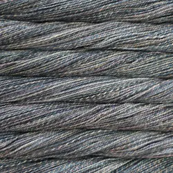 Picture of Malabrigo Torzal Mineral: A subtle, stone-inspired colorway blending heathered slate grey and muted denim blue tones, delicately interwoven with faint earthy hints of sandy beige and charcoal shading.