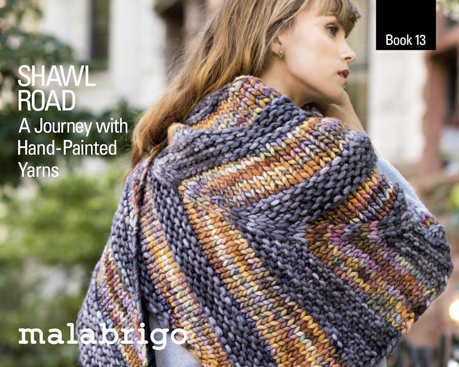 malabrigo book 13, girl in cover is wearing a knitted shawl in rasta