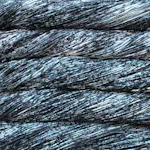 Picture of Malabrigo Arroyo Pleiades: A multi-toned yarn featuring a stony blend of dark charcoal grey and slate blue, heavily speckled with contrasting frosty white highlights.