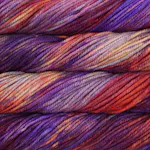 Picture of Malabrigo Chunky Archangel: A vibrant, multi-colored variegated colorway blending deep violet and jewel-toned purple with warm, sunset-inspired streaks of fiery orange, magenta, and golden yellow.