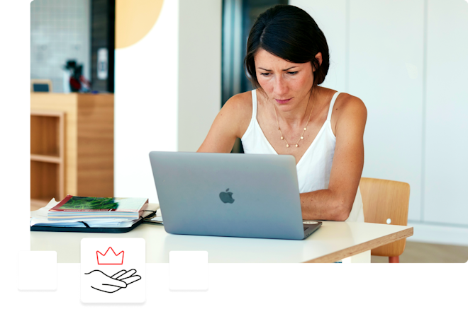 woman on a laptop with an icon of a hand and a crown