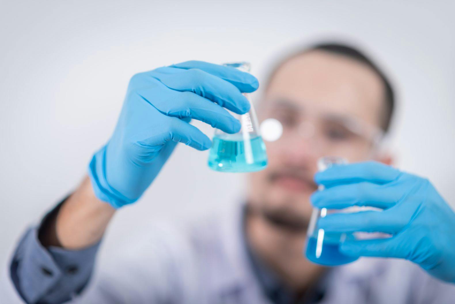 man with flask at pharma laboratory