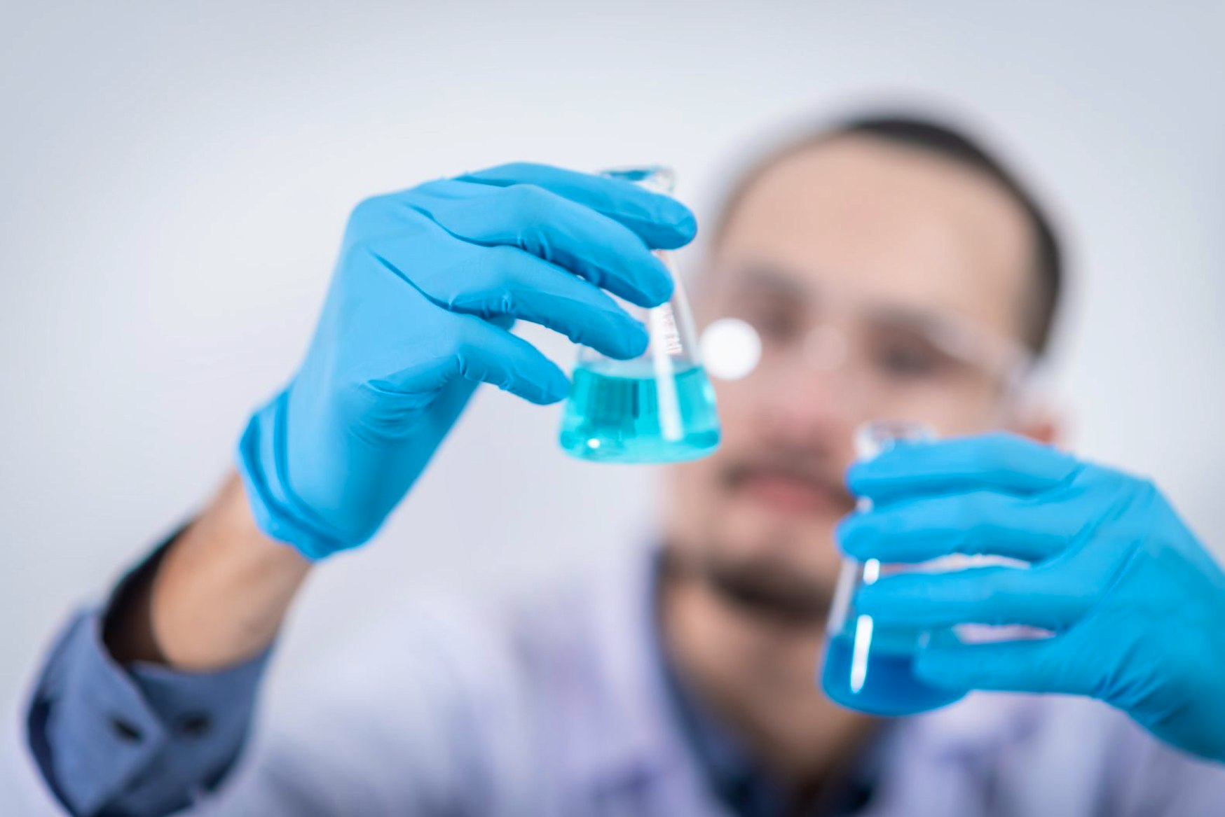 man with flask at pharma laboratory