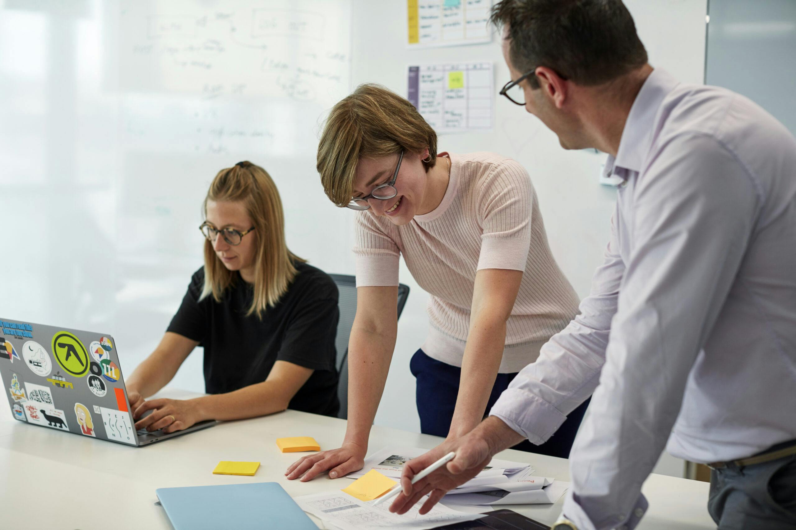 three people working together