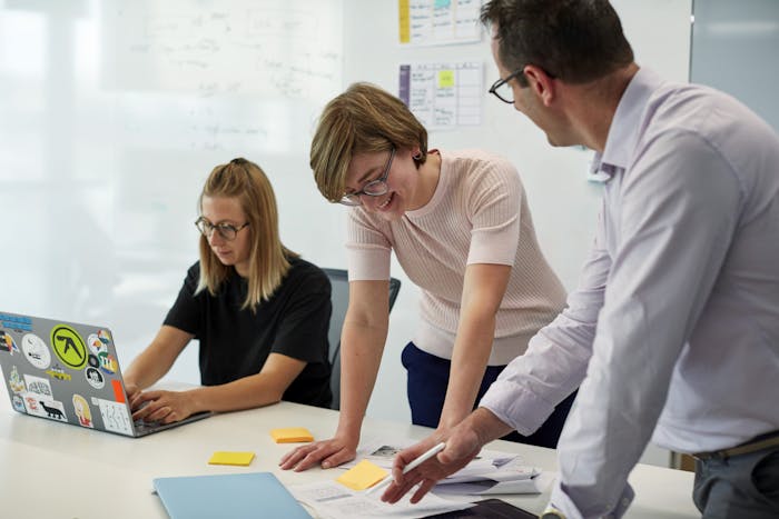 three people working together