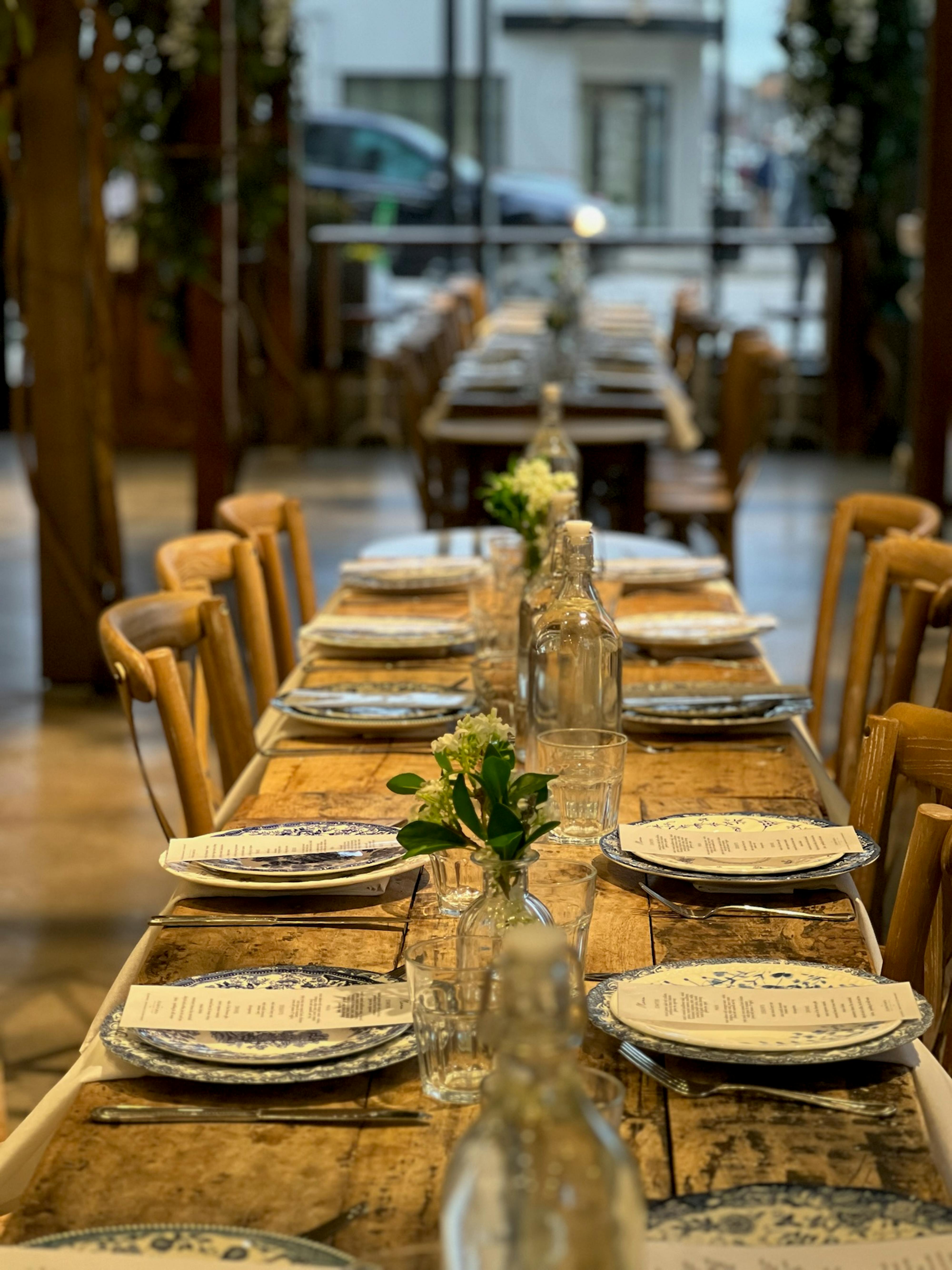 a close up shot of a romantic table setting atop a rustic farm table