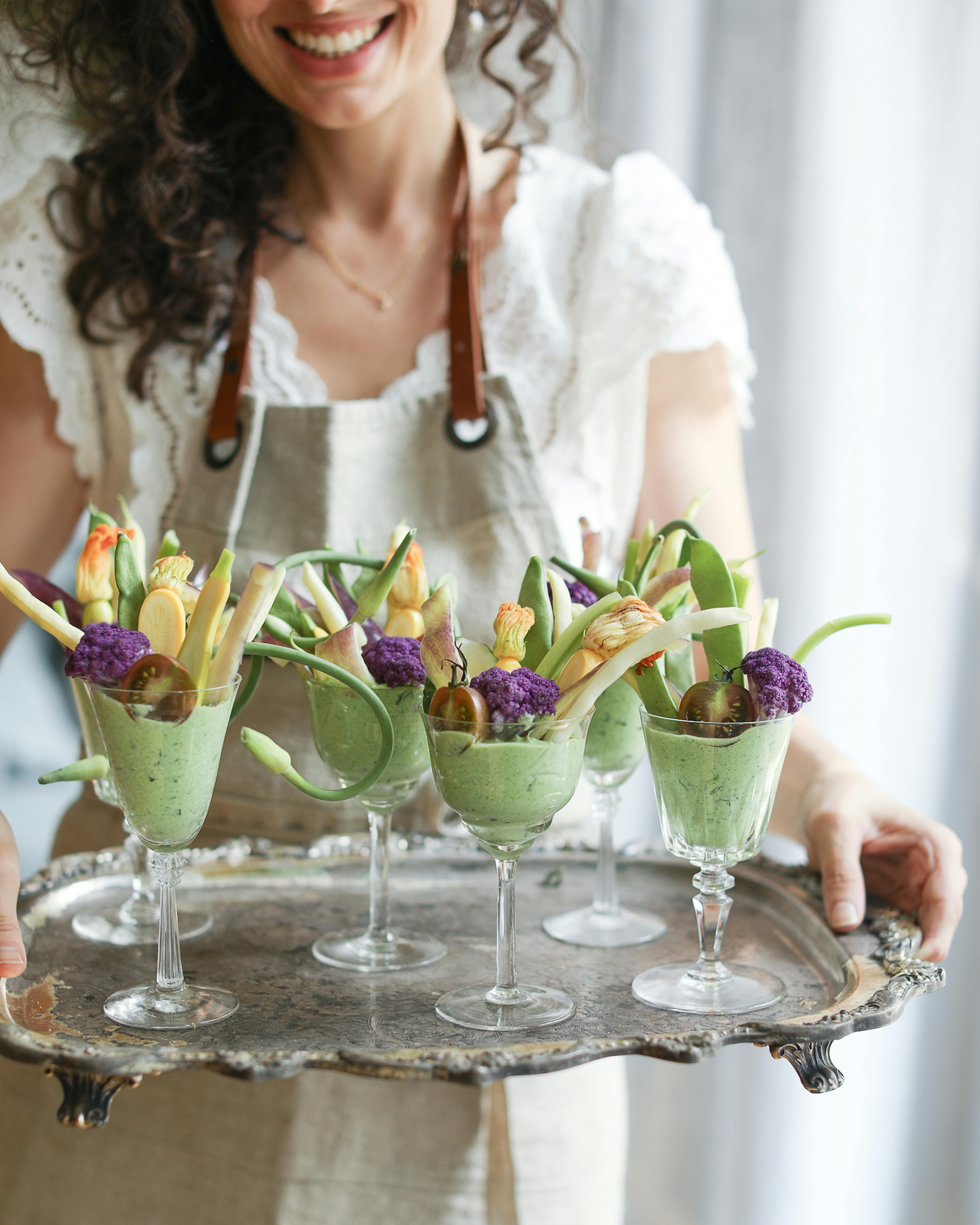 elisa holding crudité cups on a tray