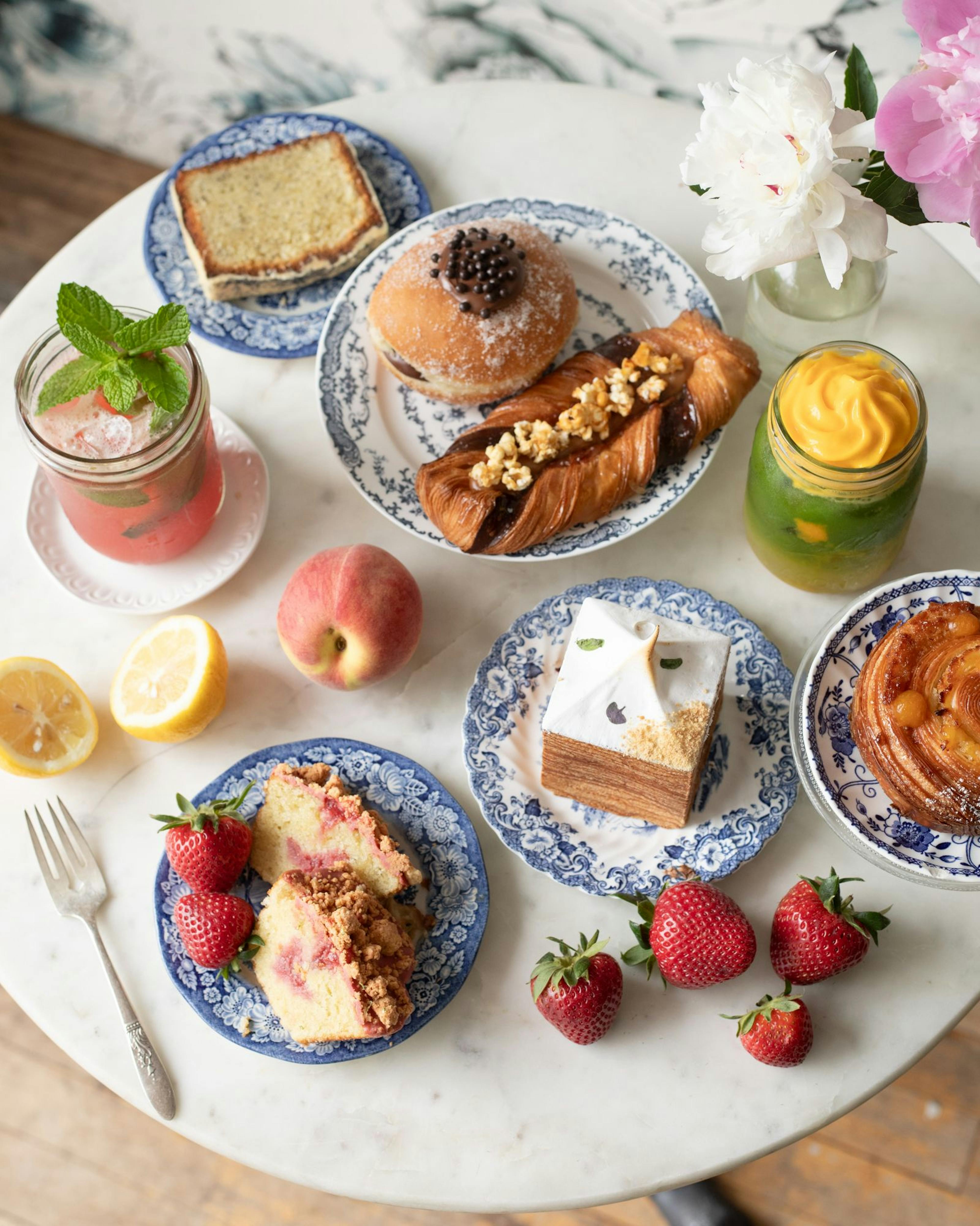 plates with pastries, beverages and fruit 
