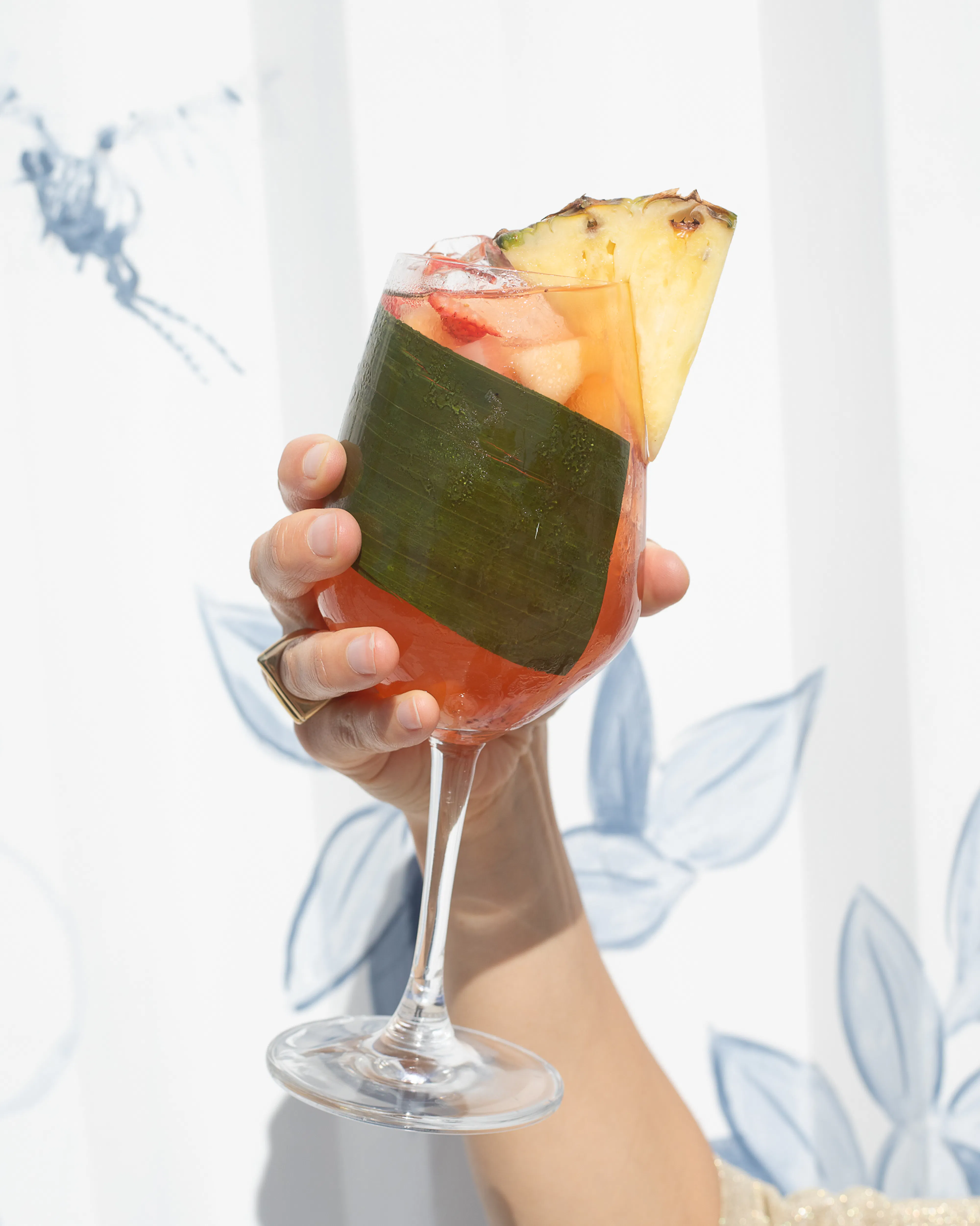 person holding a wine glass of sangria
