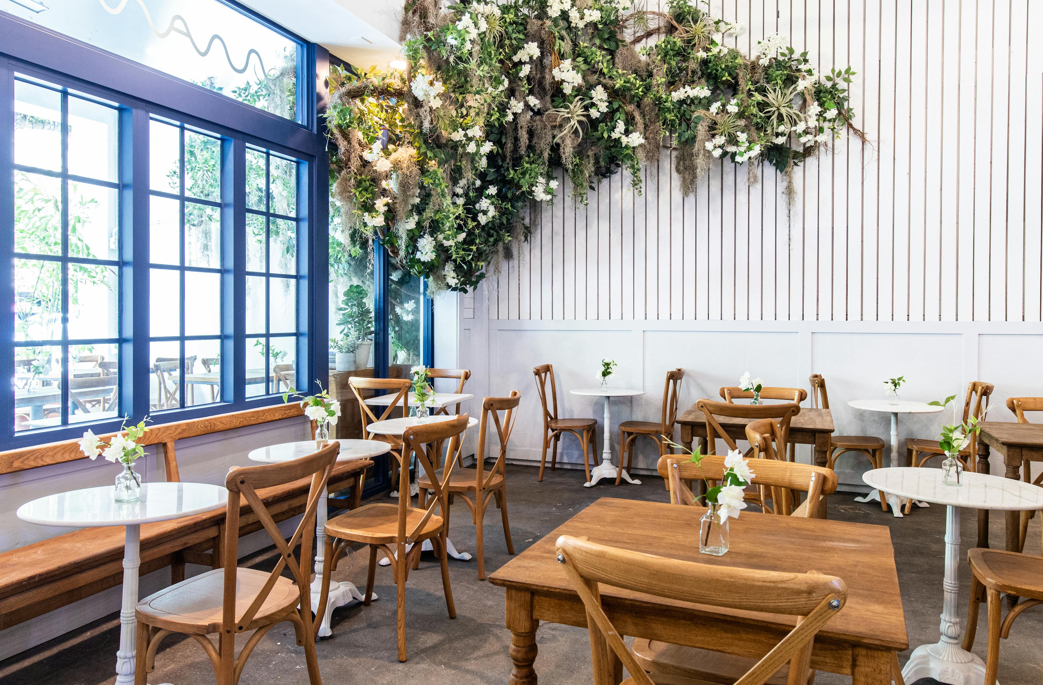 cafe with tables, chairs, window, and flowering tree