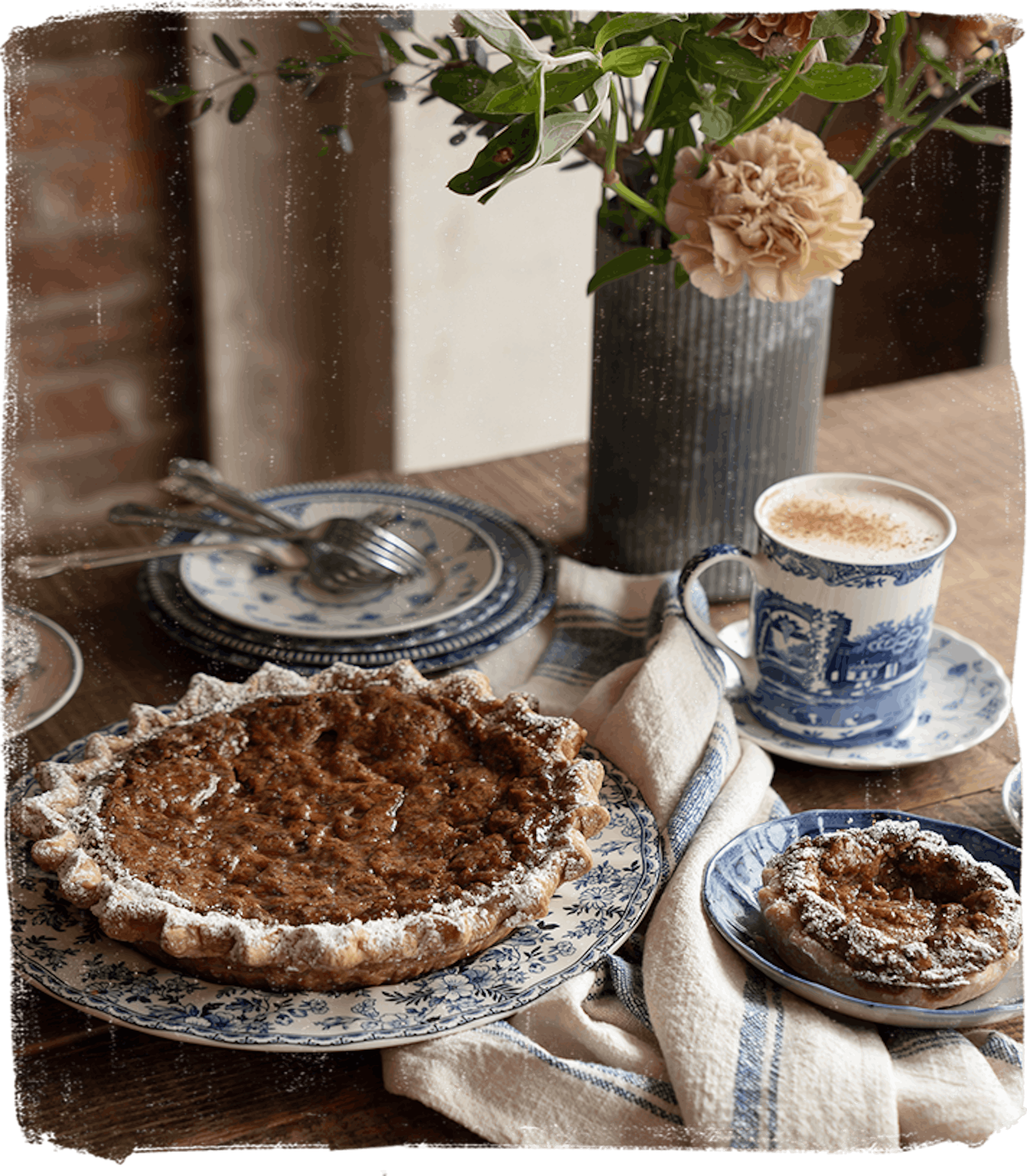 pecan pie on table with flowers & coffee