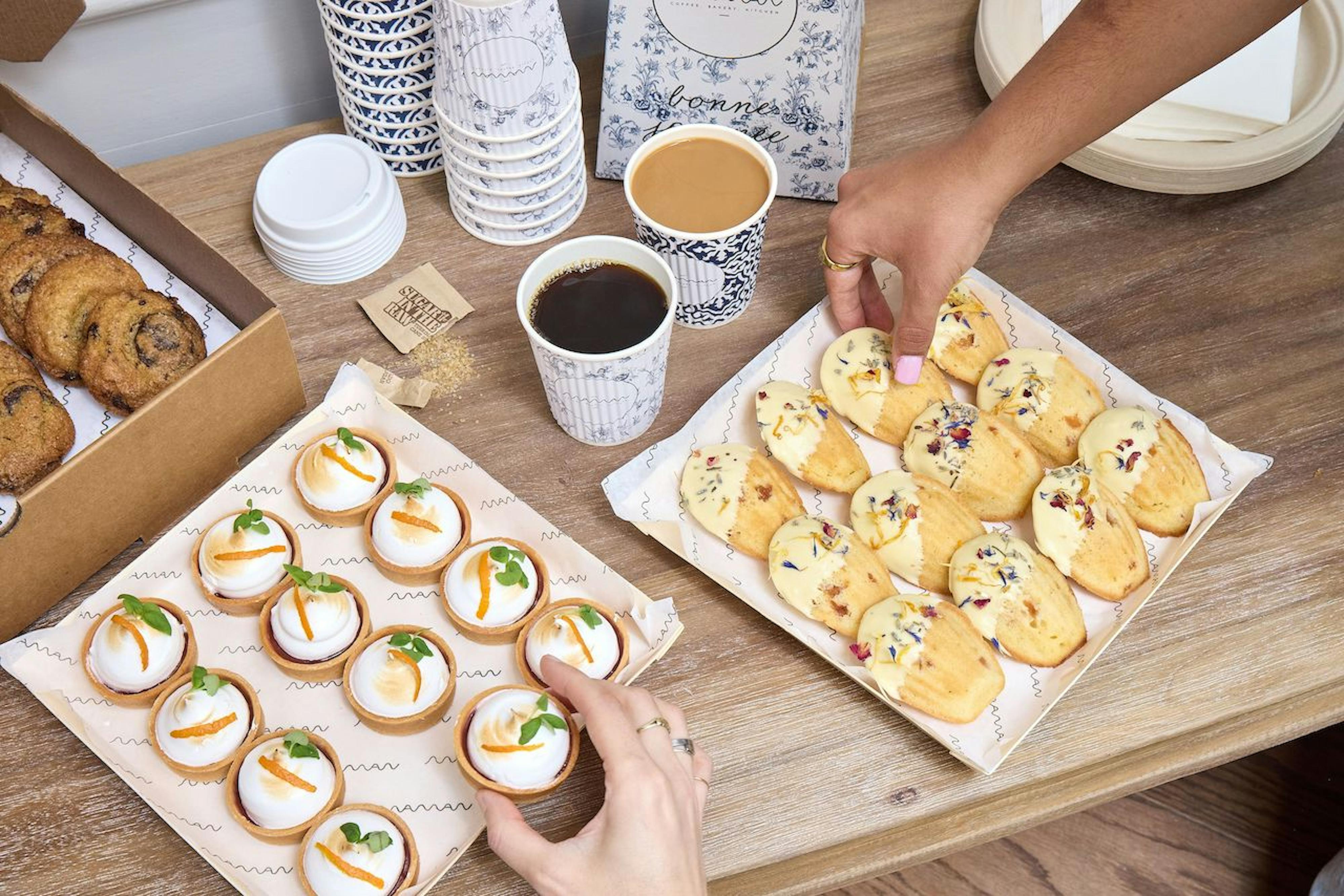 catering platters with hands reaching for sweets