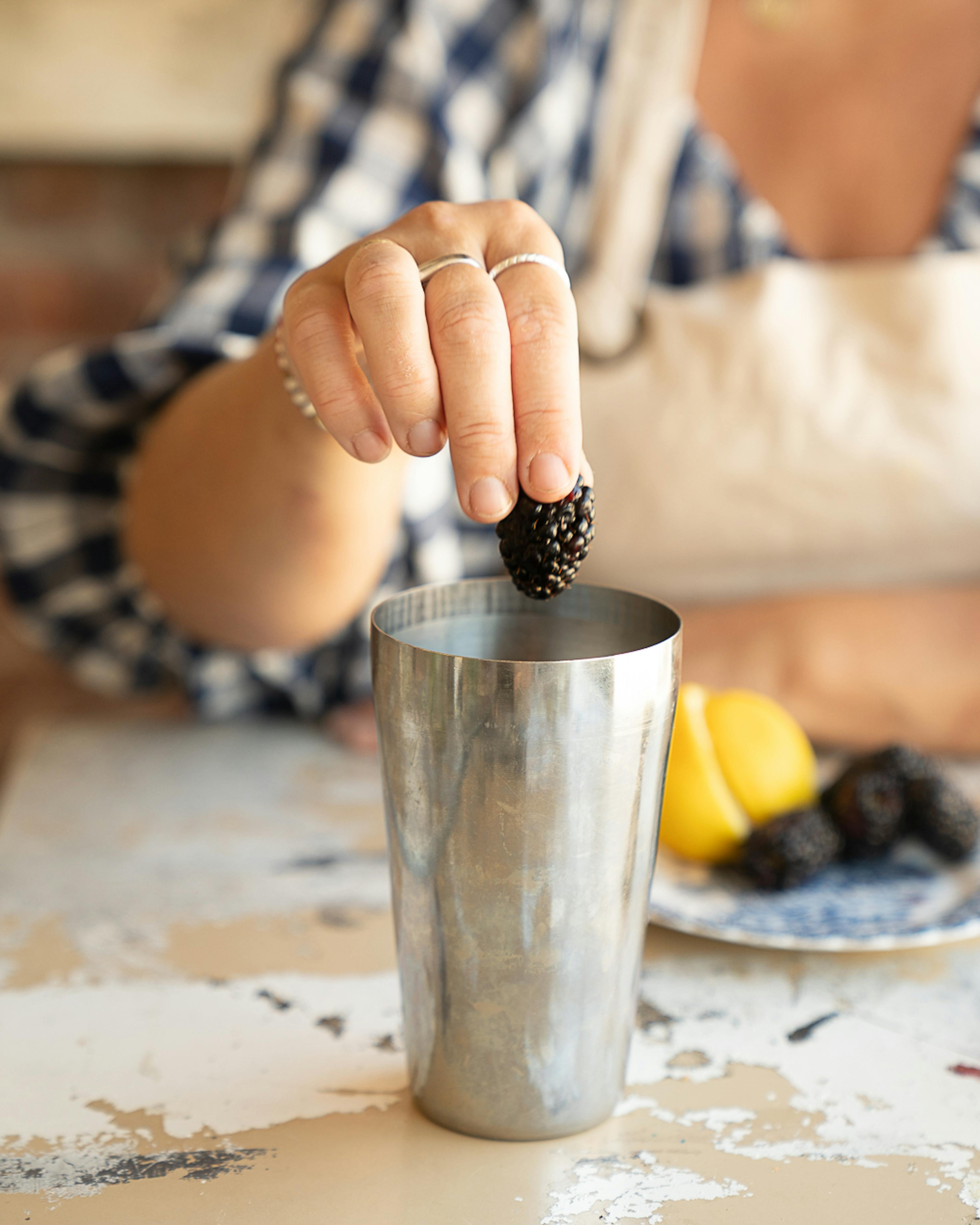 adding blackberry to cocktail shaker