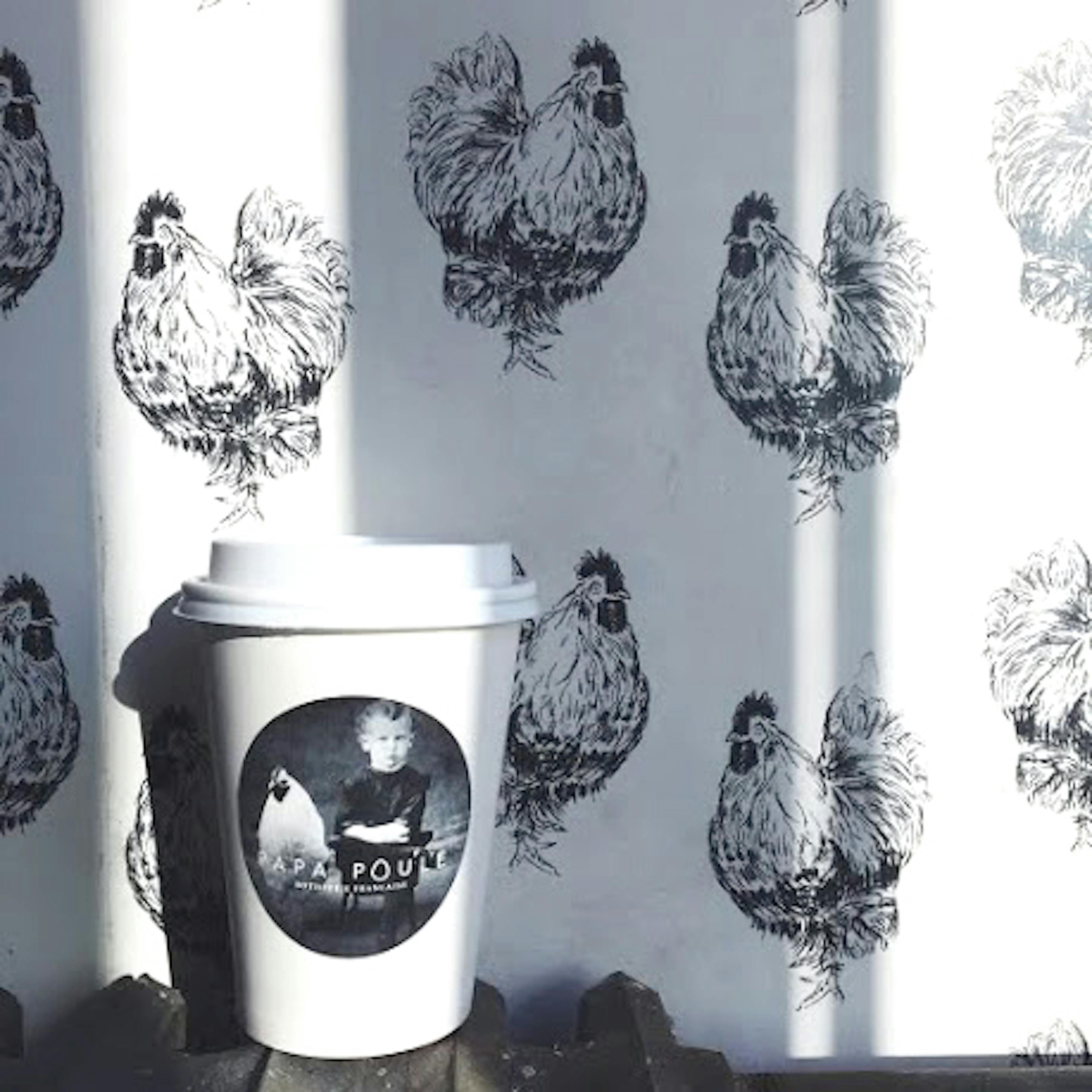 papa poule cup next to chicken wallpaper