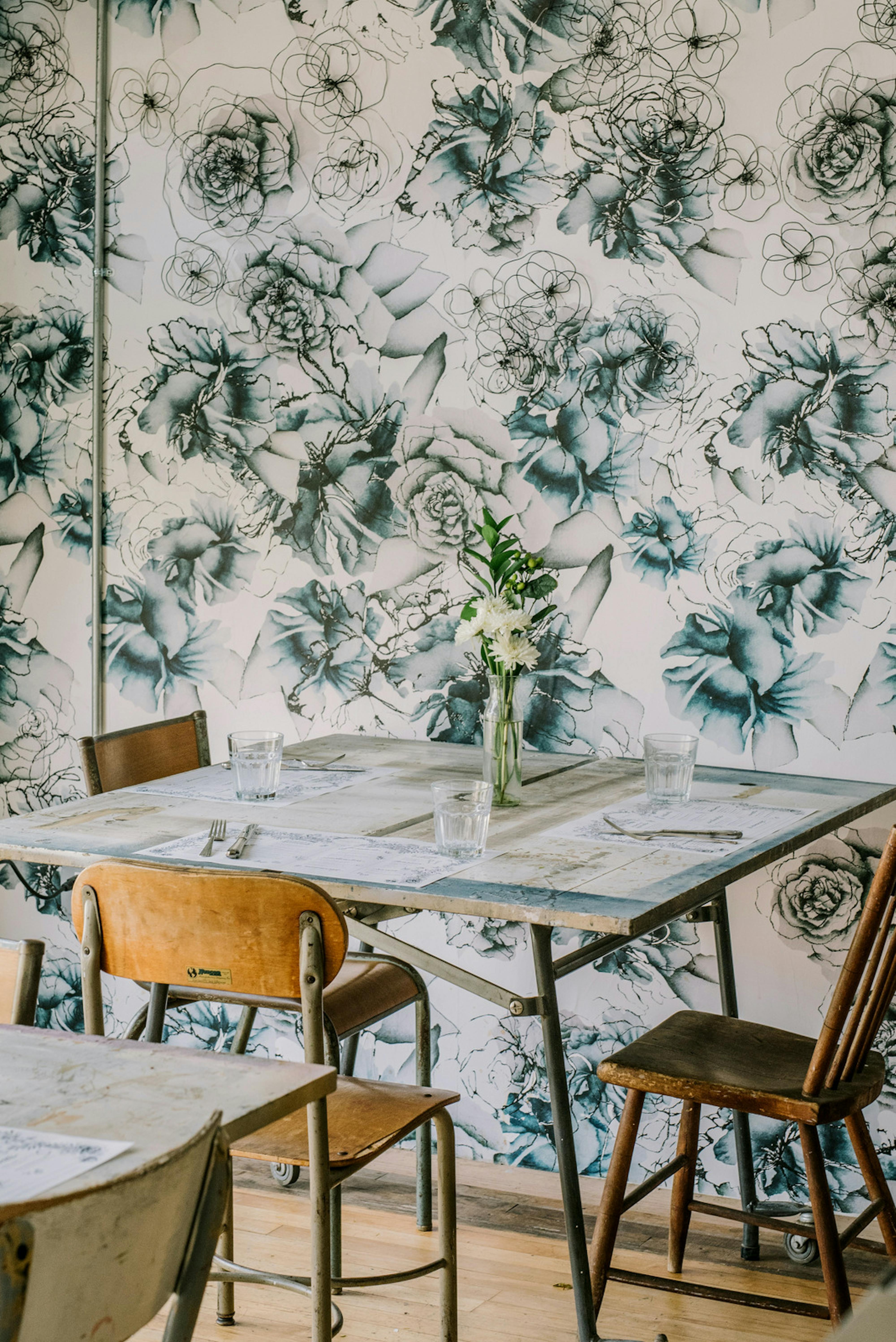 table by floral wallpaper