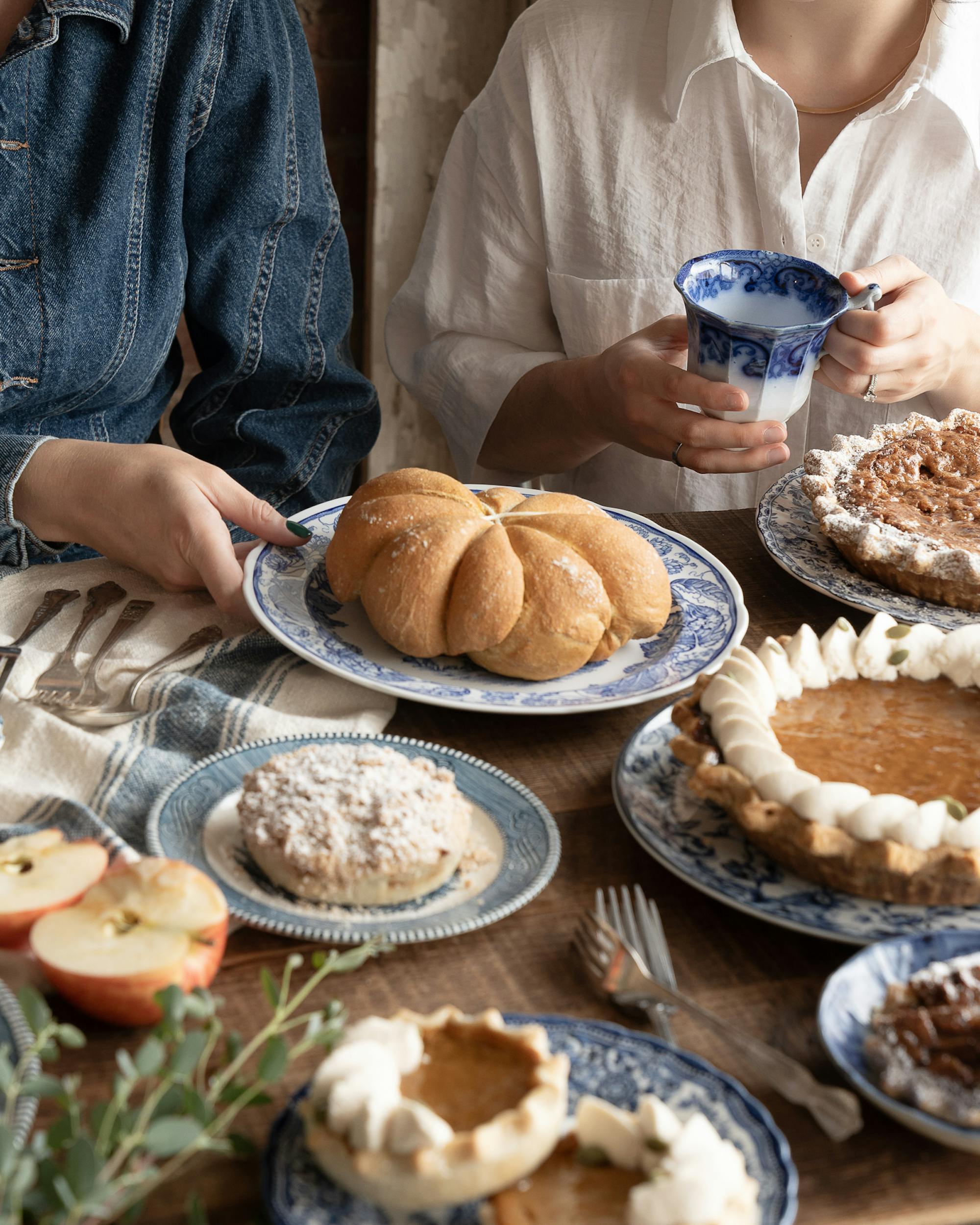 thanksgiving spread with pies and loaves