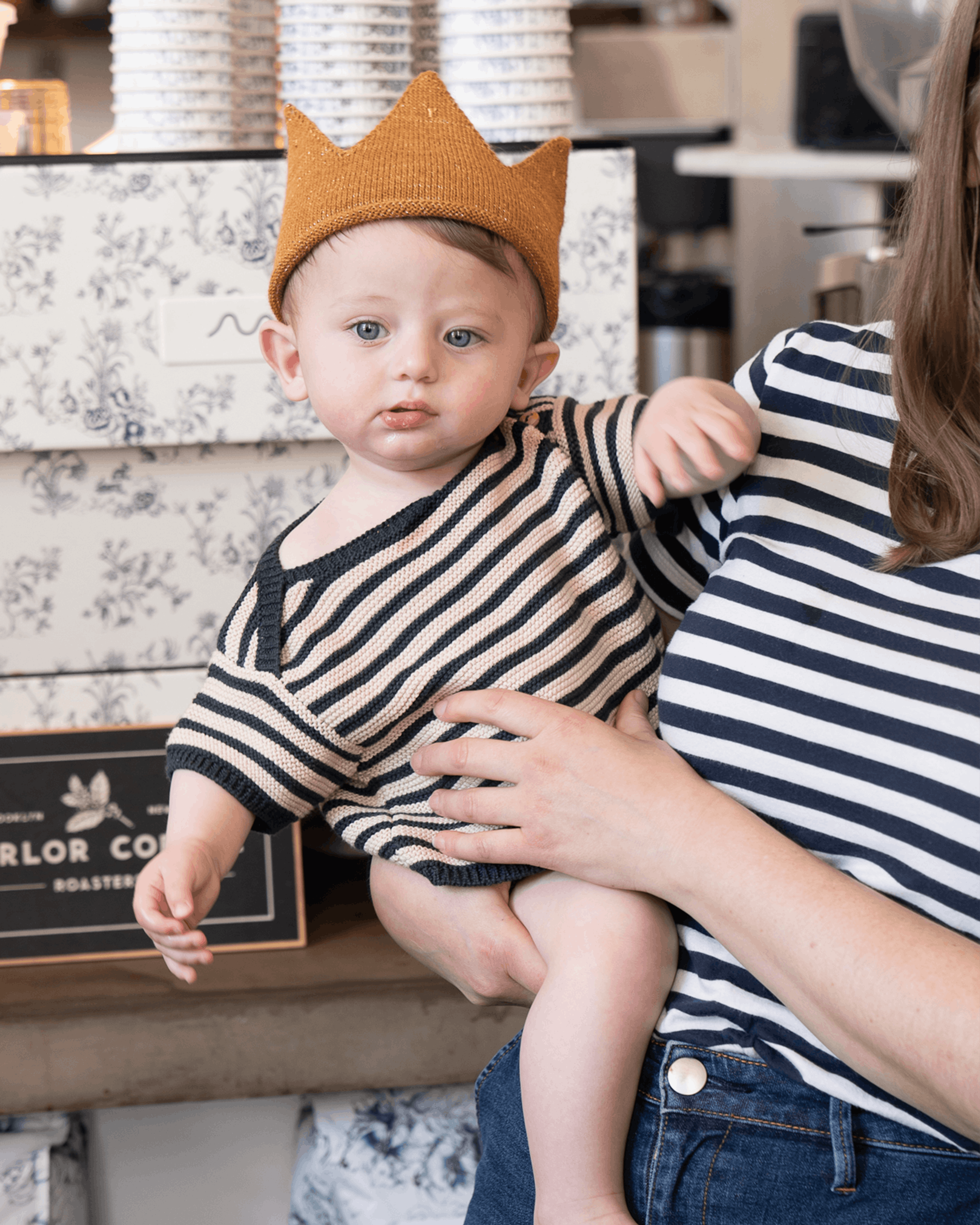 baby in striped sweater and crown