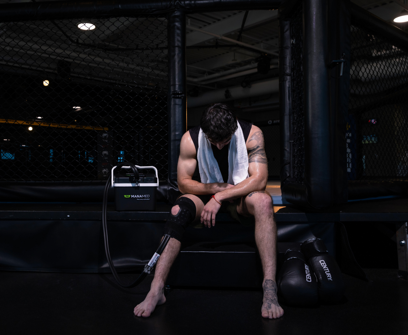 Athlete using ManaCold Therapy Unit ringside at a UFC match.