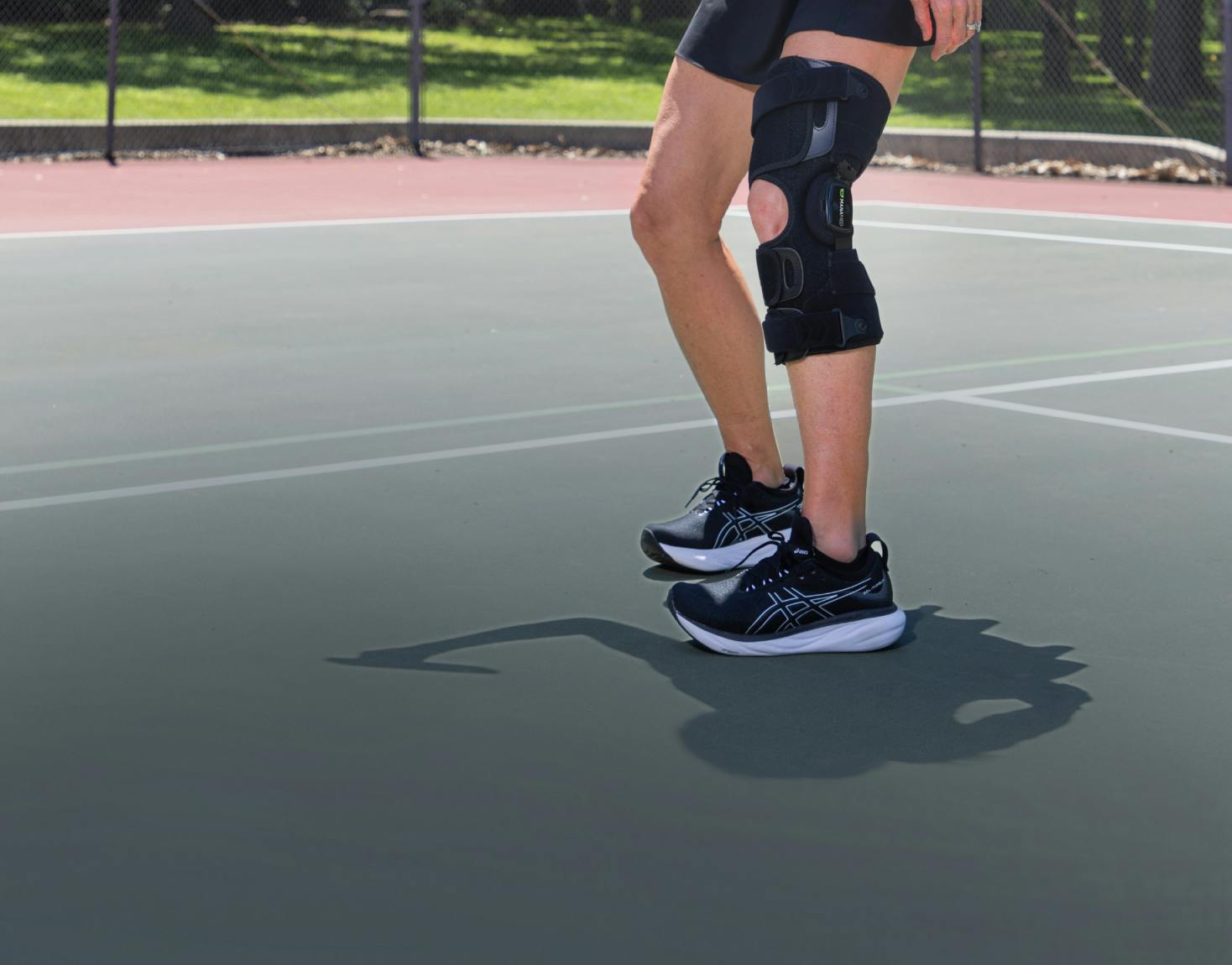 woman playing pickleball wearing GOAT knee brace