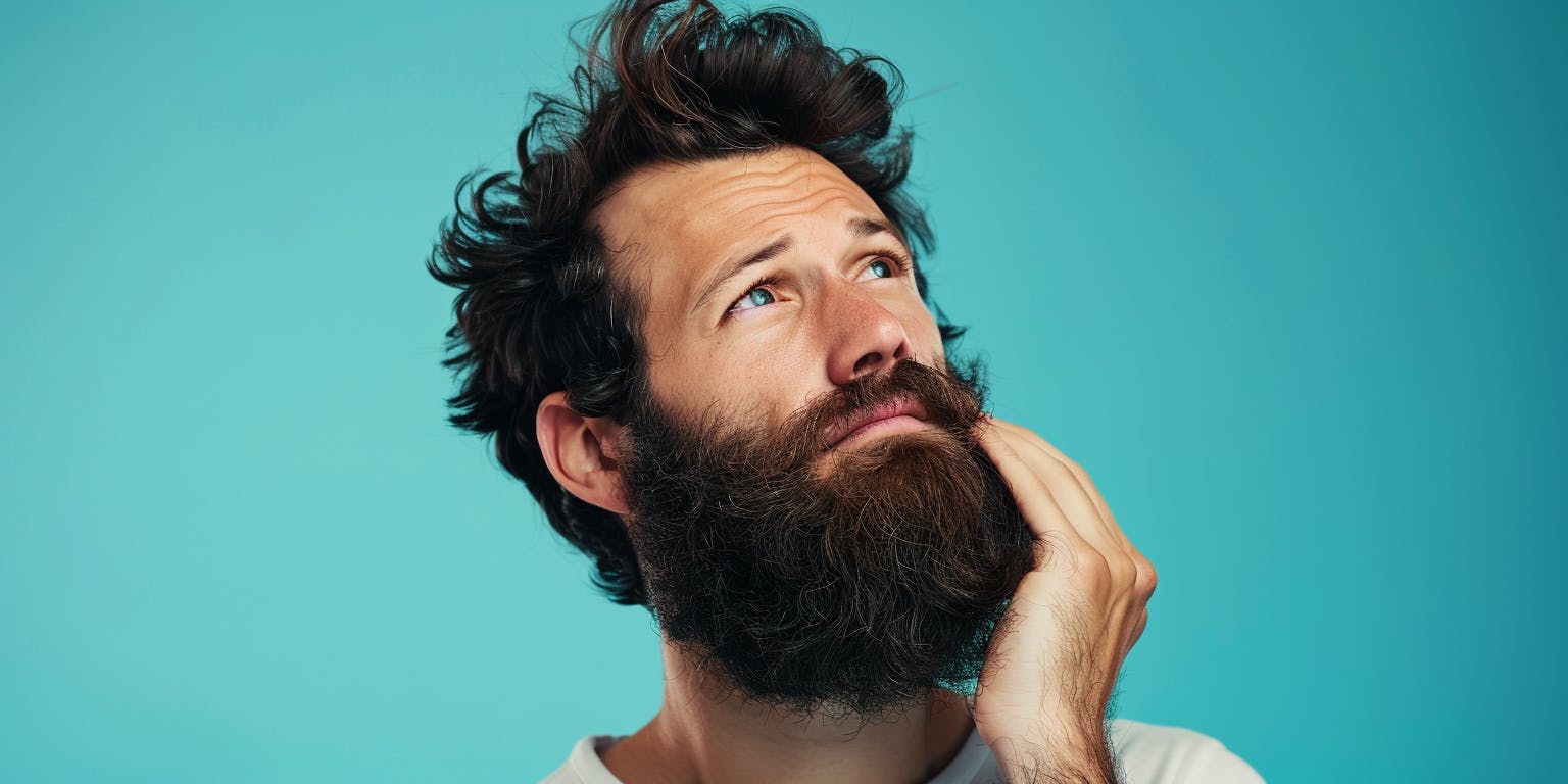 A man scratching his beard.