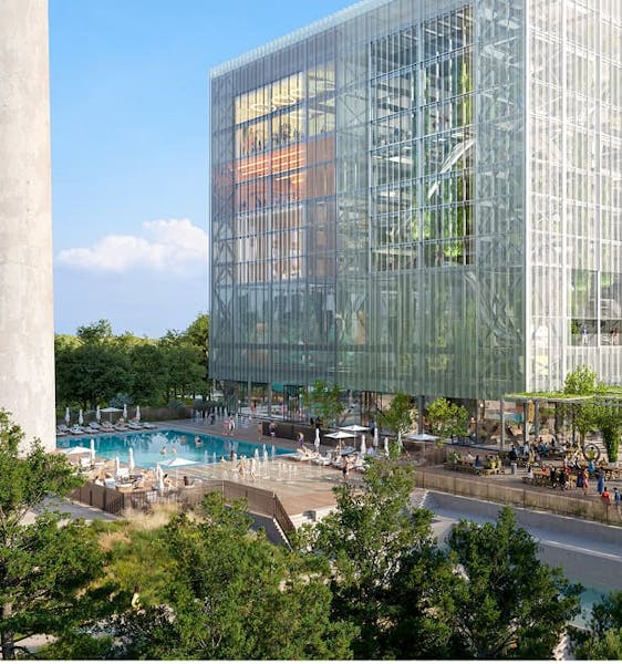 Dozens of people walking the grounds of a multi-story building and a large community pool all surrounded by manicured lawns.