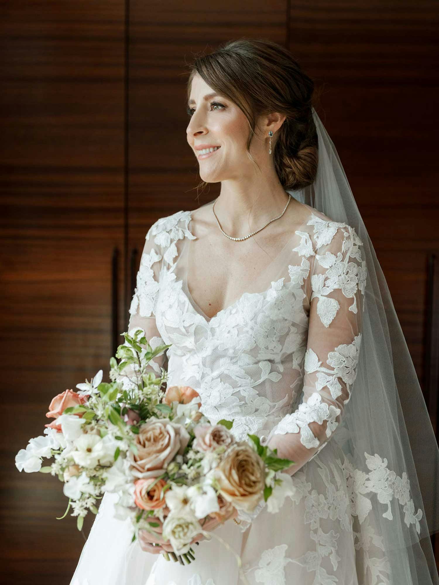 brunette bride holding flower bouquet