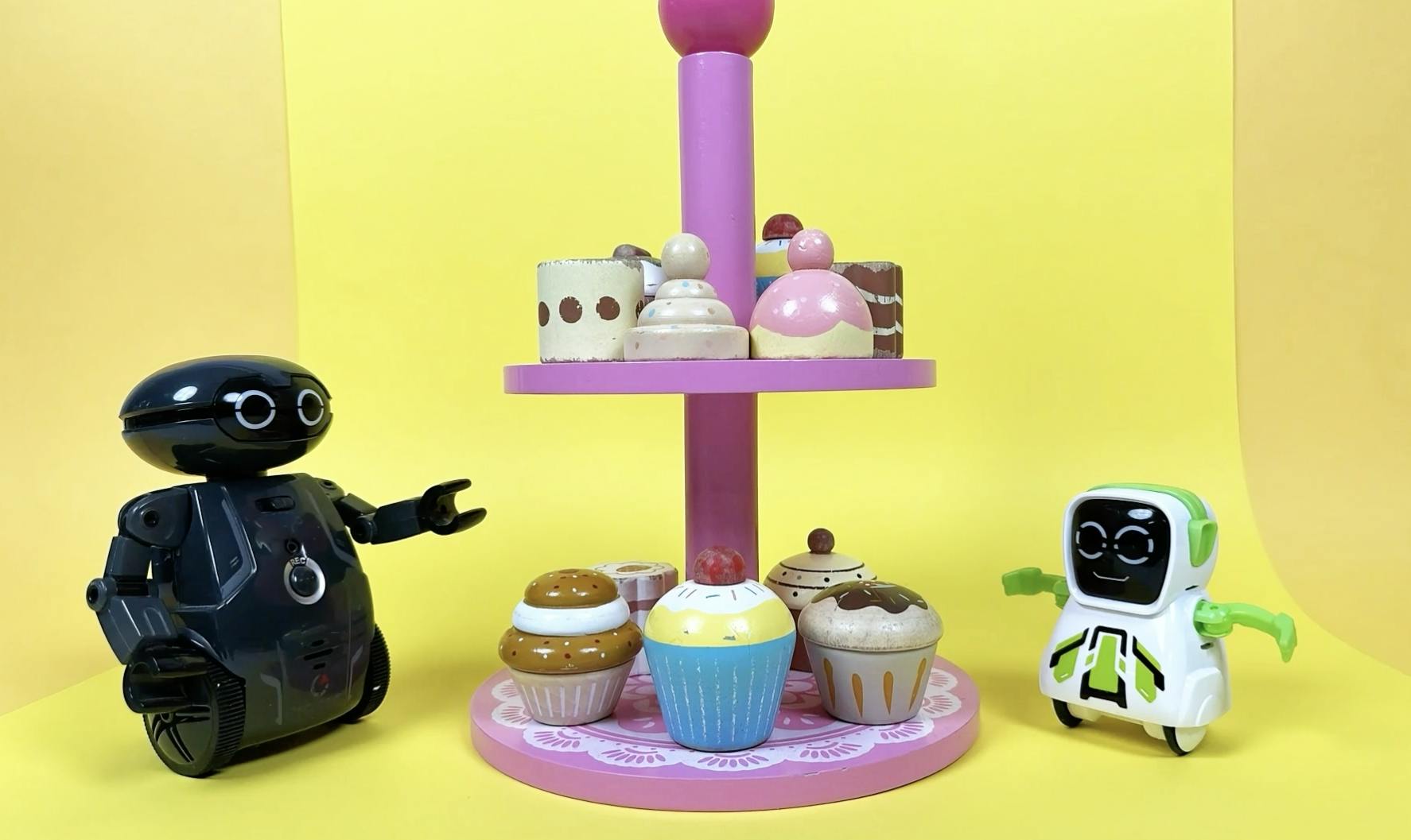 Two toy robots having sweets