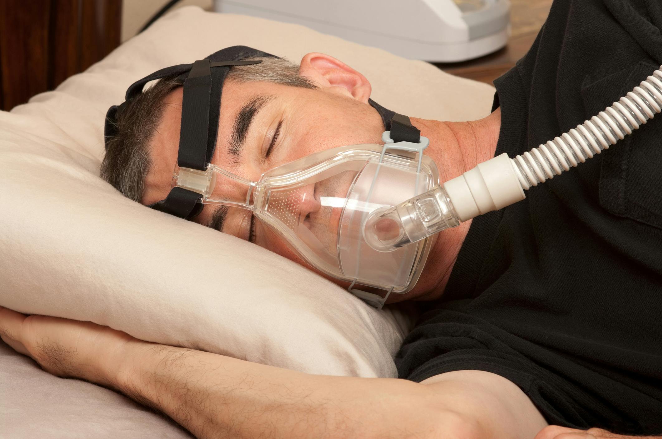 man wearing sleep apnea mask 