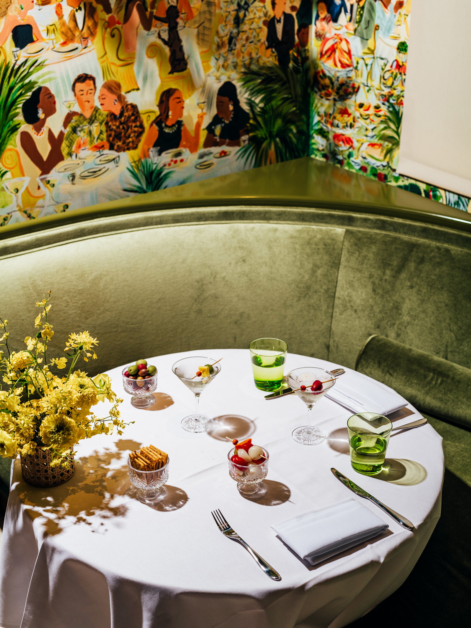 A table set with snacks and cocktails.
