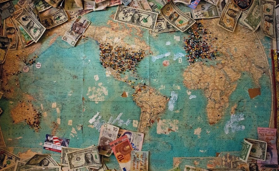 Worldwide locations marked by pins and money on the map as the target of localization